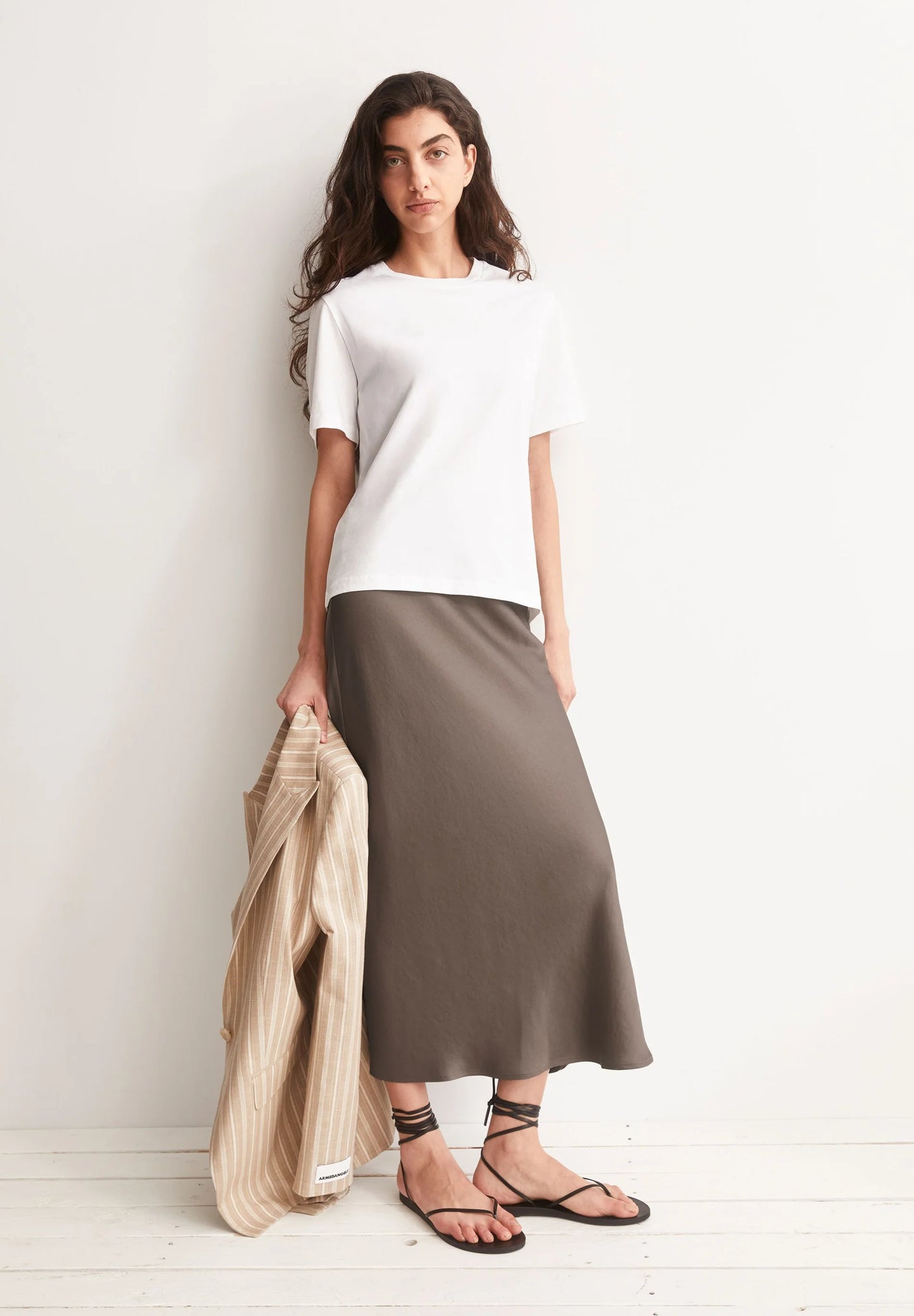 LENOVAA SATIN SLIP-SKIRT in Walnut Creme - ARMEDANGELS Canada styled shot with white t-shirt and a blazer in Kelowna