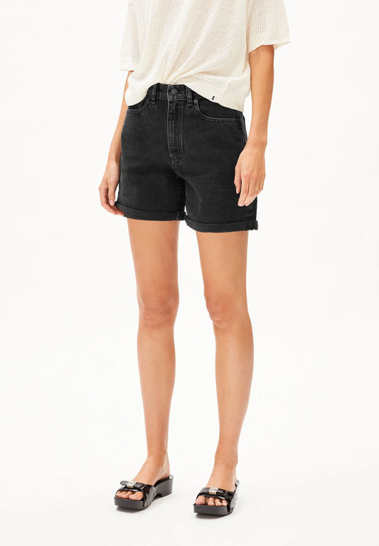 Person wearing black denim shorts on a white background for Kelowna and Canada