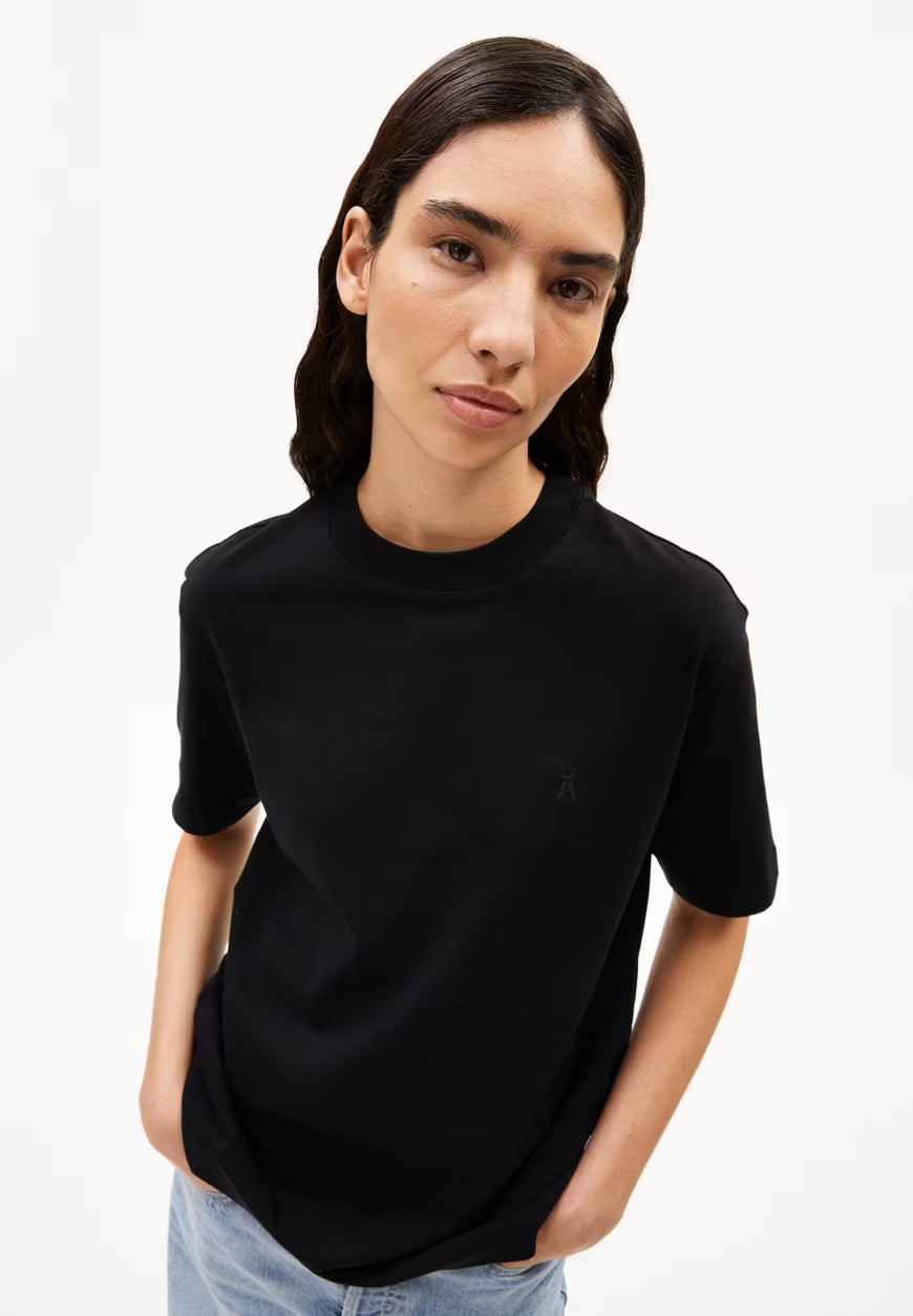 Woman wearing a black t-shirt against a white background