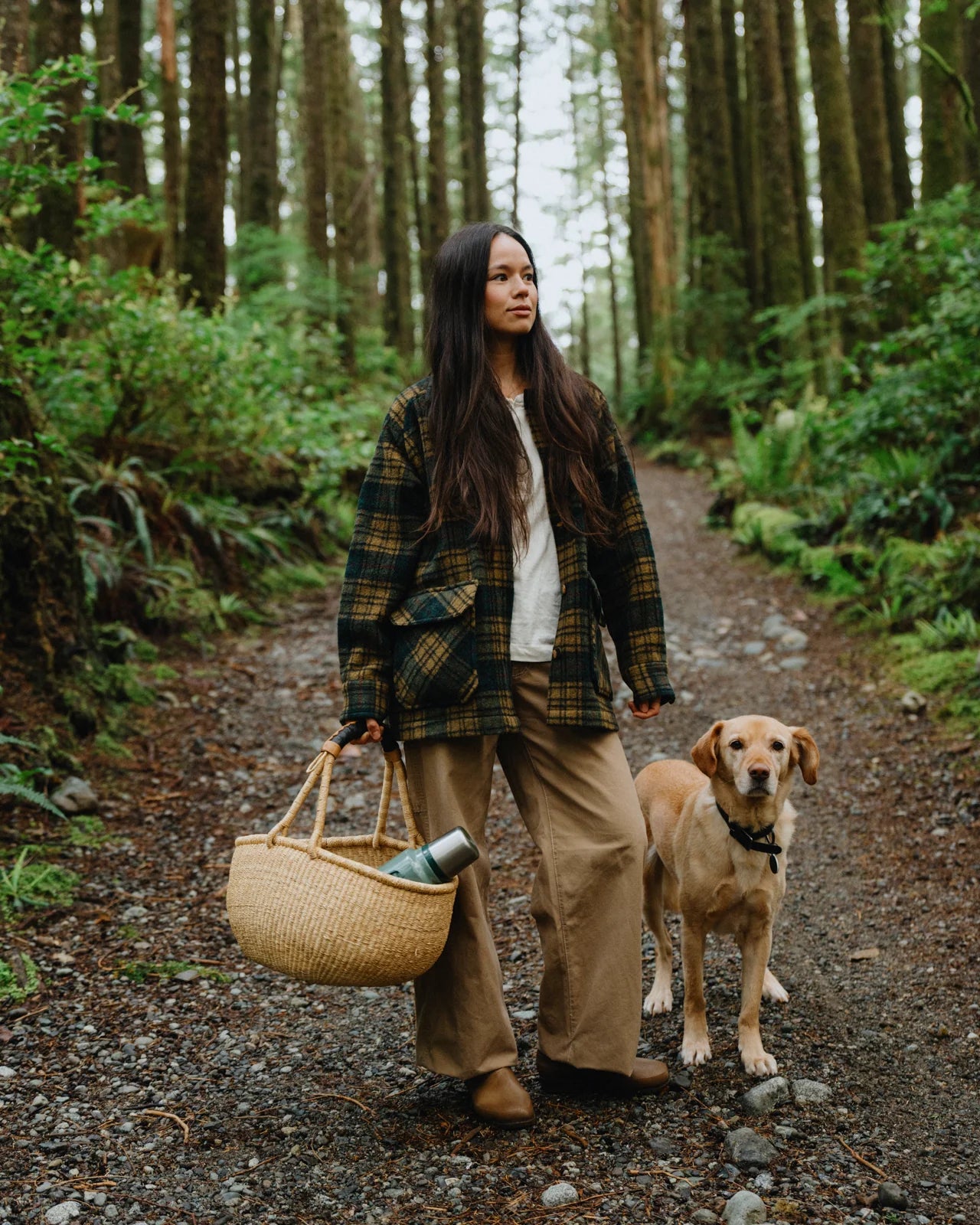 Anian Georgia coat plaid worn by a woman outdoors with a dog, featuring a stylish and cozy design in Kelowna