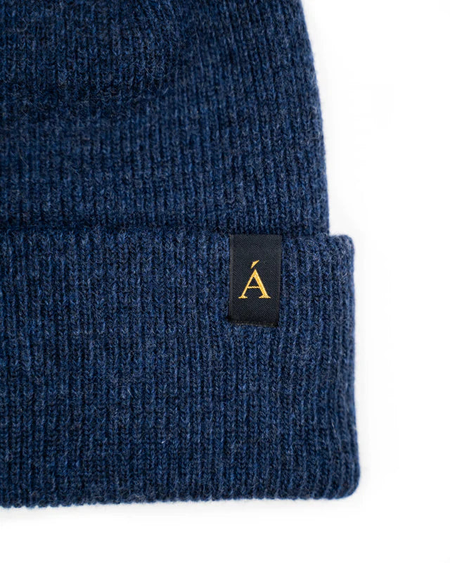 Anian navy blue ribbed knit cuff wool toque with folded hem and black tag featuring gold logo in Keowna