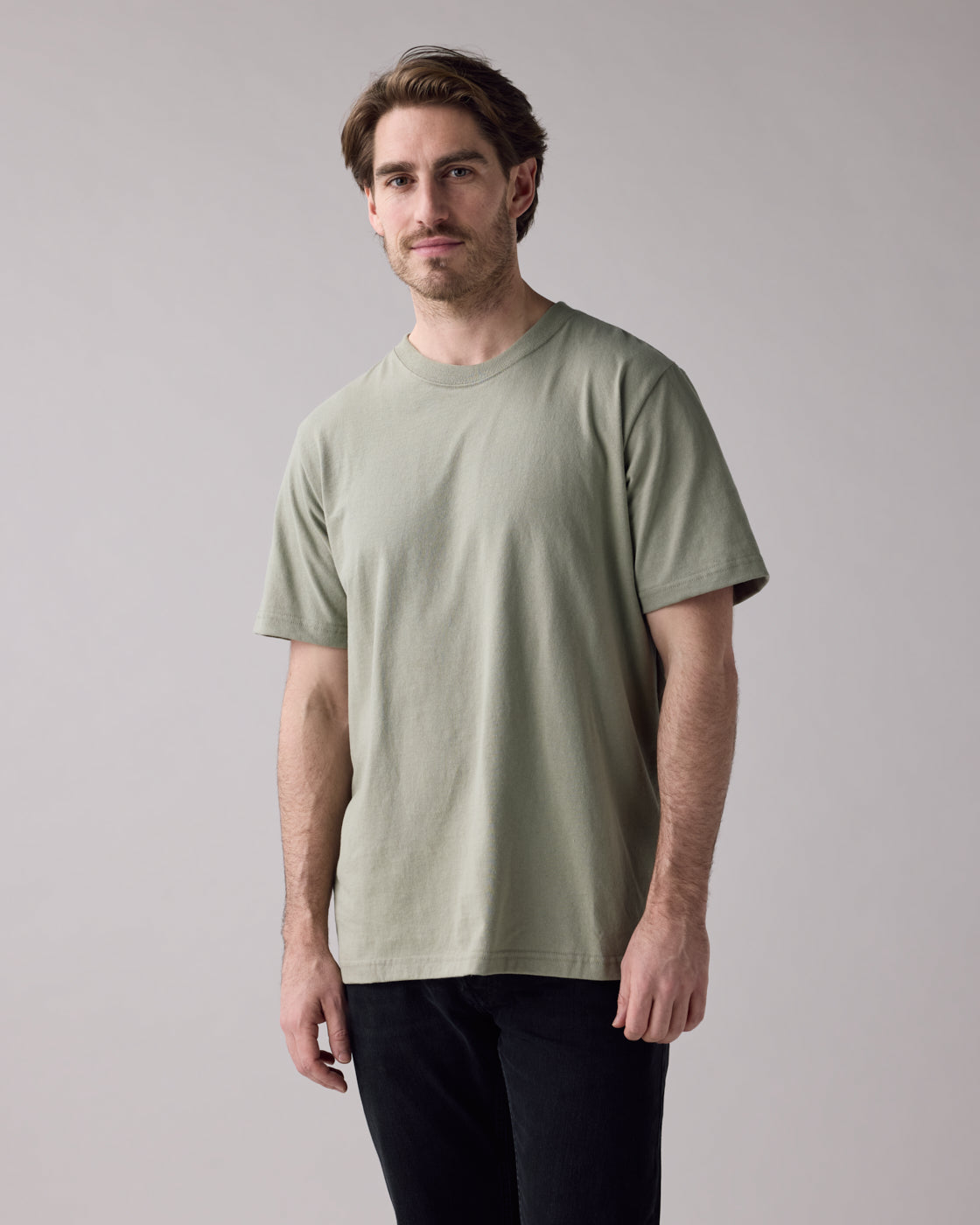 Anian mens unisex relaxed fit sage green crew neck cotton t-shirt on model with black jeans in kelowna