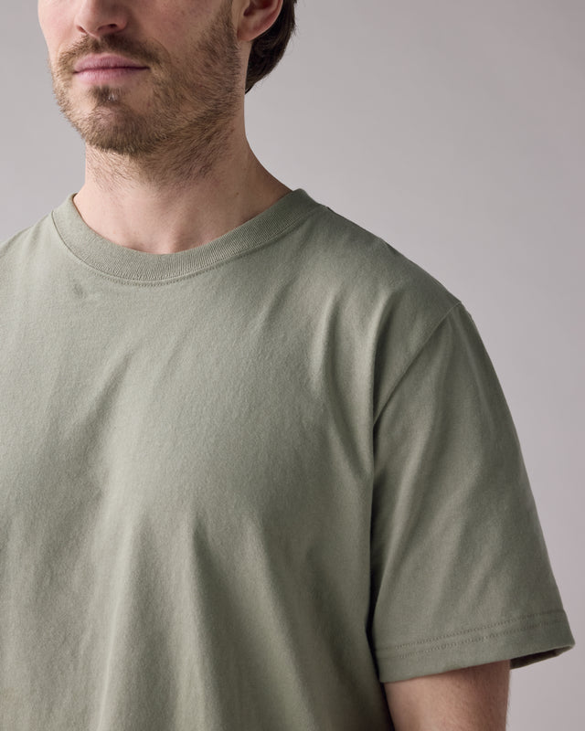 Anian mens olive green crew neck t-shirt on model showing short sleeves and relaxed fit in Kelowna