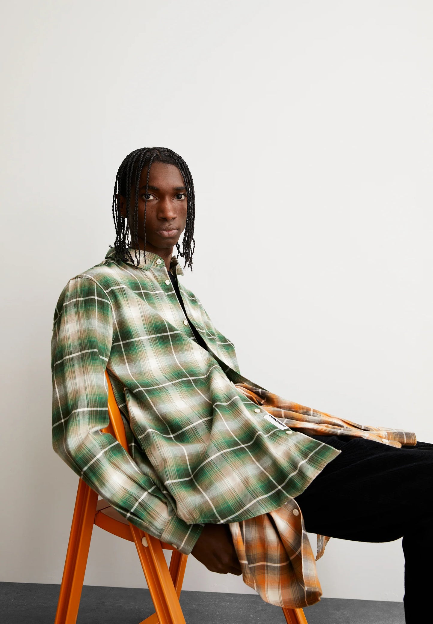 ARMEDANGELS Canada Men's Long Sleeve Plaid Shirt in Green and Plaid Pattern Sitting on a Chair in Kelowna and Canada