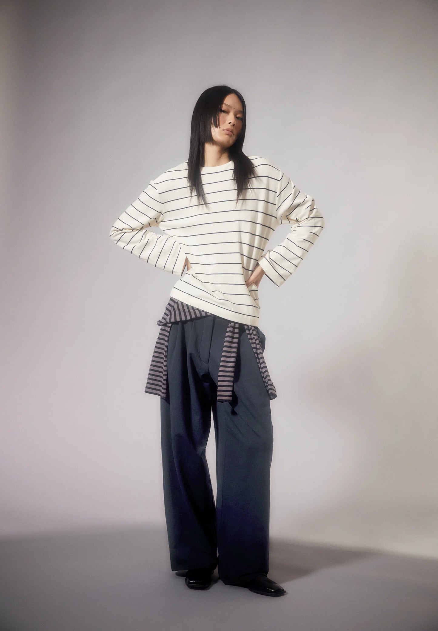ARMEDANGELS Canada striped shirt in cream with black stripes, styled with wide navy pants in Kelowna and Canada