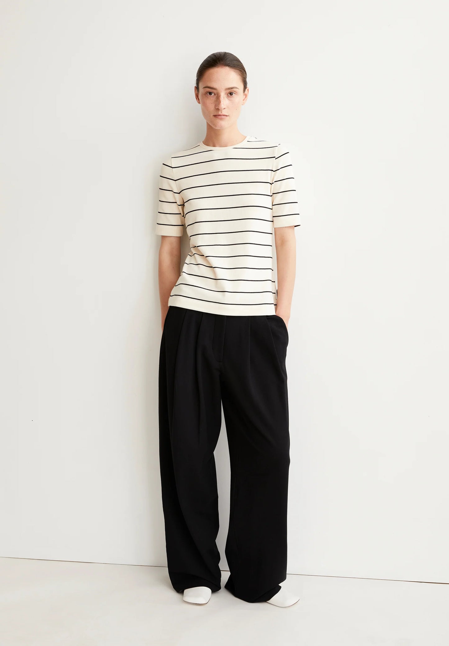ARMEDANGELS Canada striped t-shirt featuring a classic crew neckline and short sleeves, styled with black pants in Canada