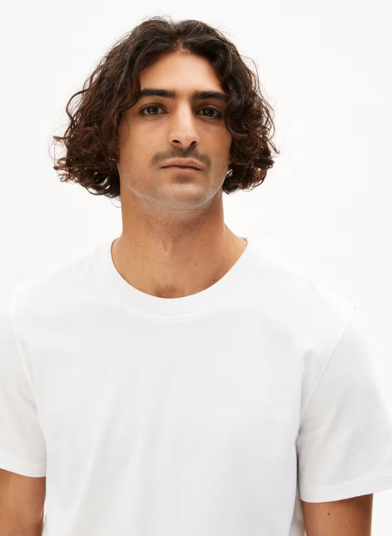 ARMEDANGELS Canada MAARKOS White T-shirt worn by male model with curly hair in studio setting in Kelowna
