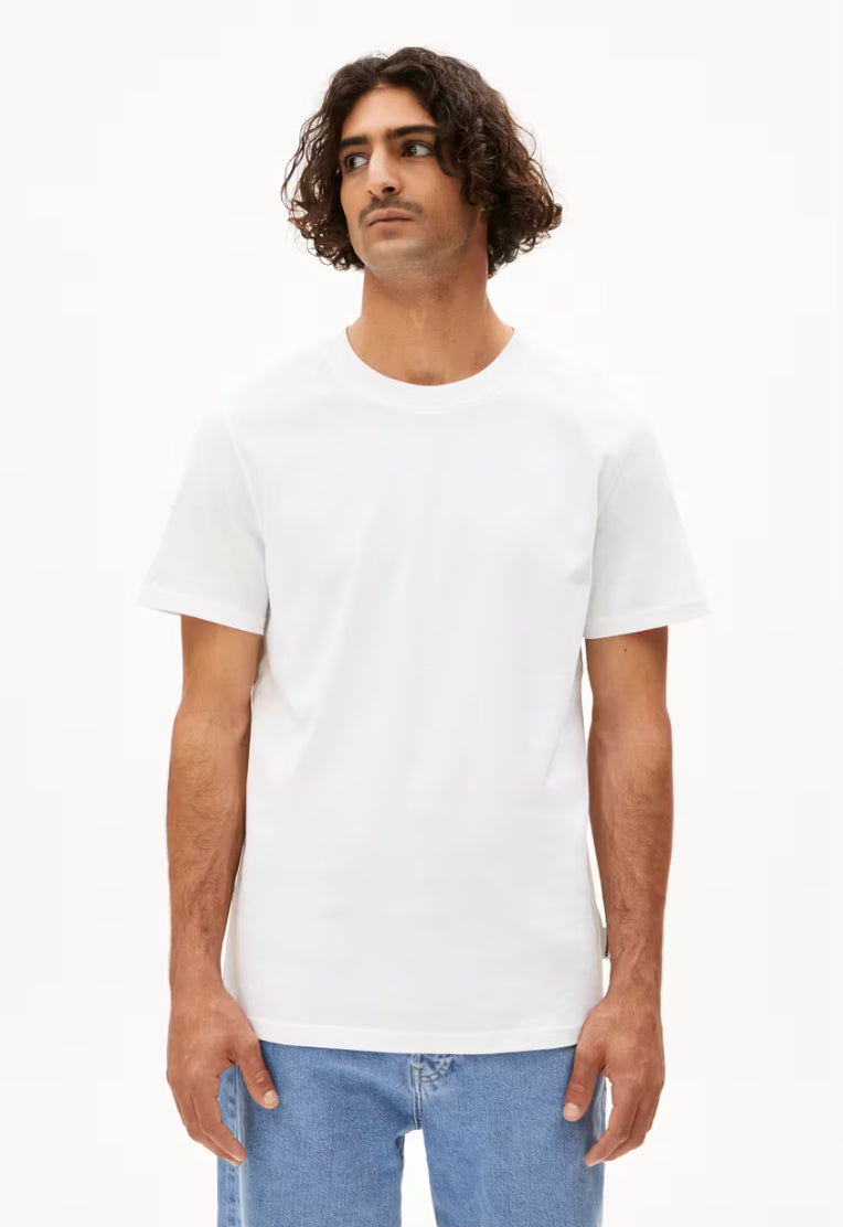 ARMEDANGELS Canada MAARKOS White T-shirt worn by male model with curly hair and blue jeans in Kelowna