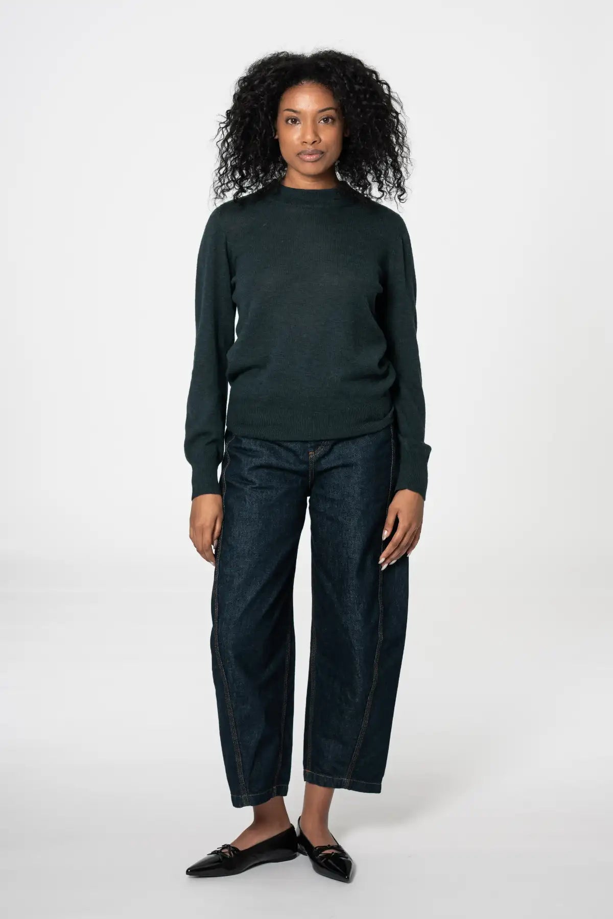 Dinadi womens merino wool sweater in dark green, paired with relaxed-fit denim pants in Kelowna and Canada