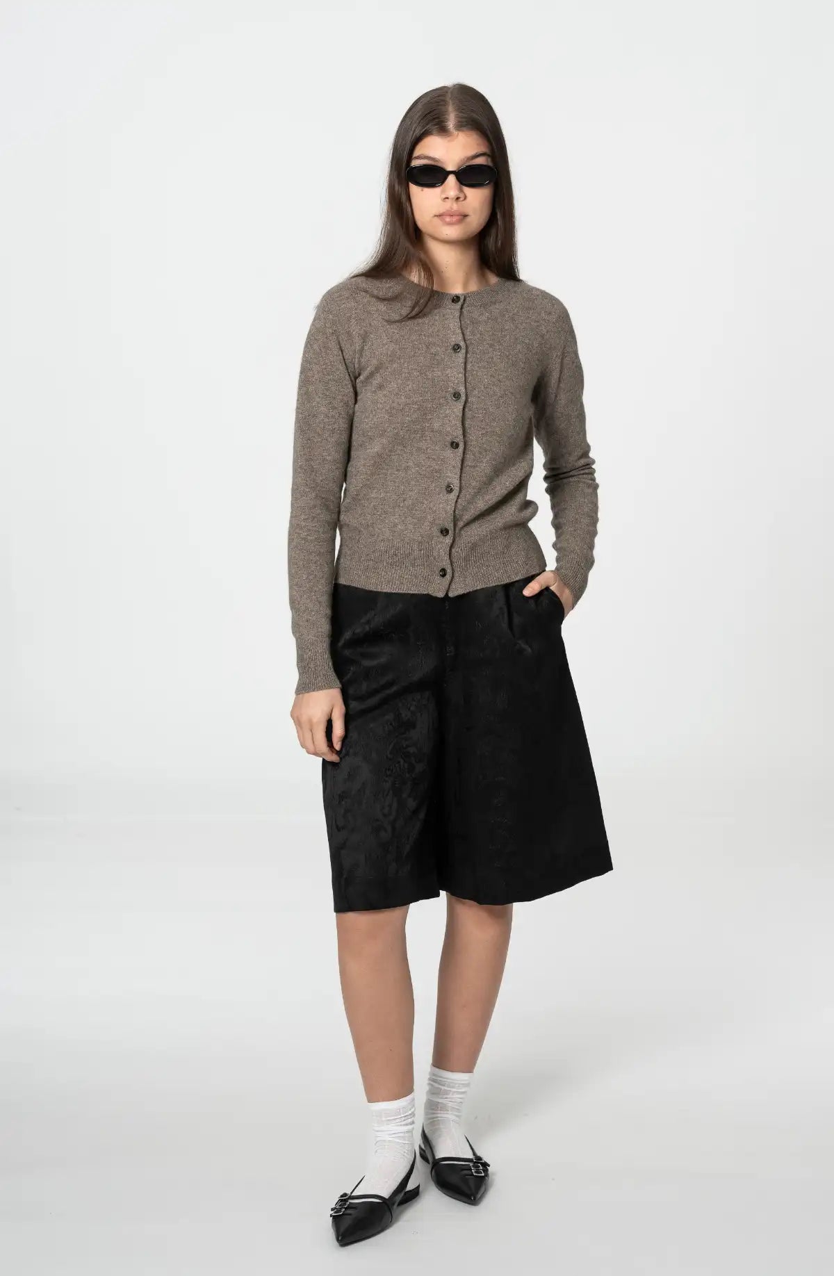 Dinadi taupe cardigan with buttons, styled with black shorts and sunglasses for a chic look in Kelowna and Canada