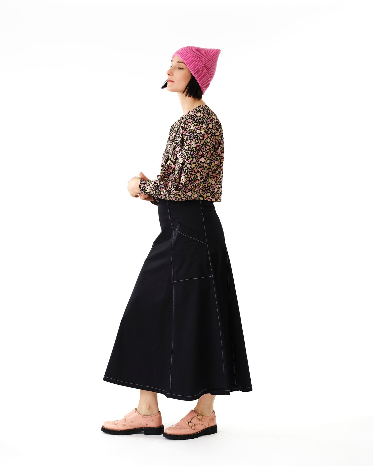 Jennifer Glasgow Design model in floral long sleeve blouse paired with black A line skirt and pink beanie in Kelowna