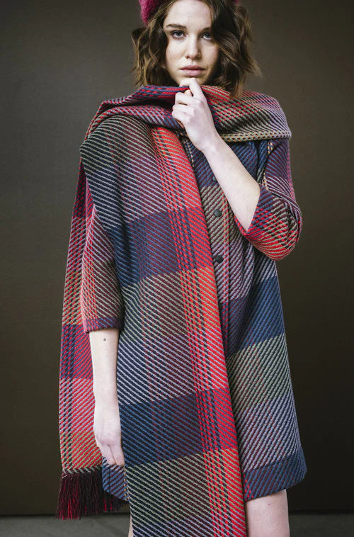 Model wearing a stylish plaid scarf in vibrant colors from BodyBag by Jude for a cozy look
