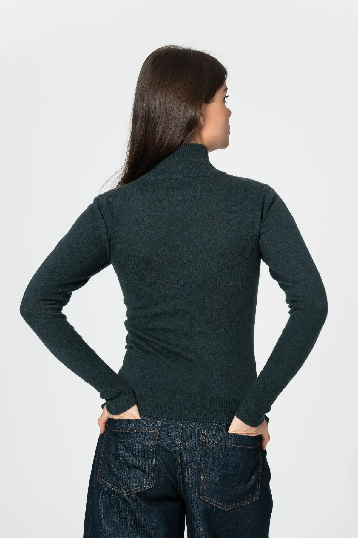 Back view of women's merino turtleneck sweater in dark green, designed for warmth and comfort