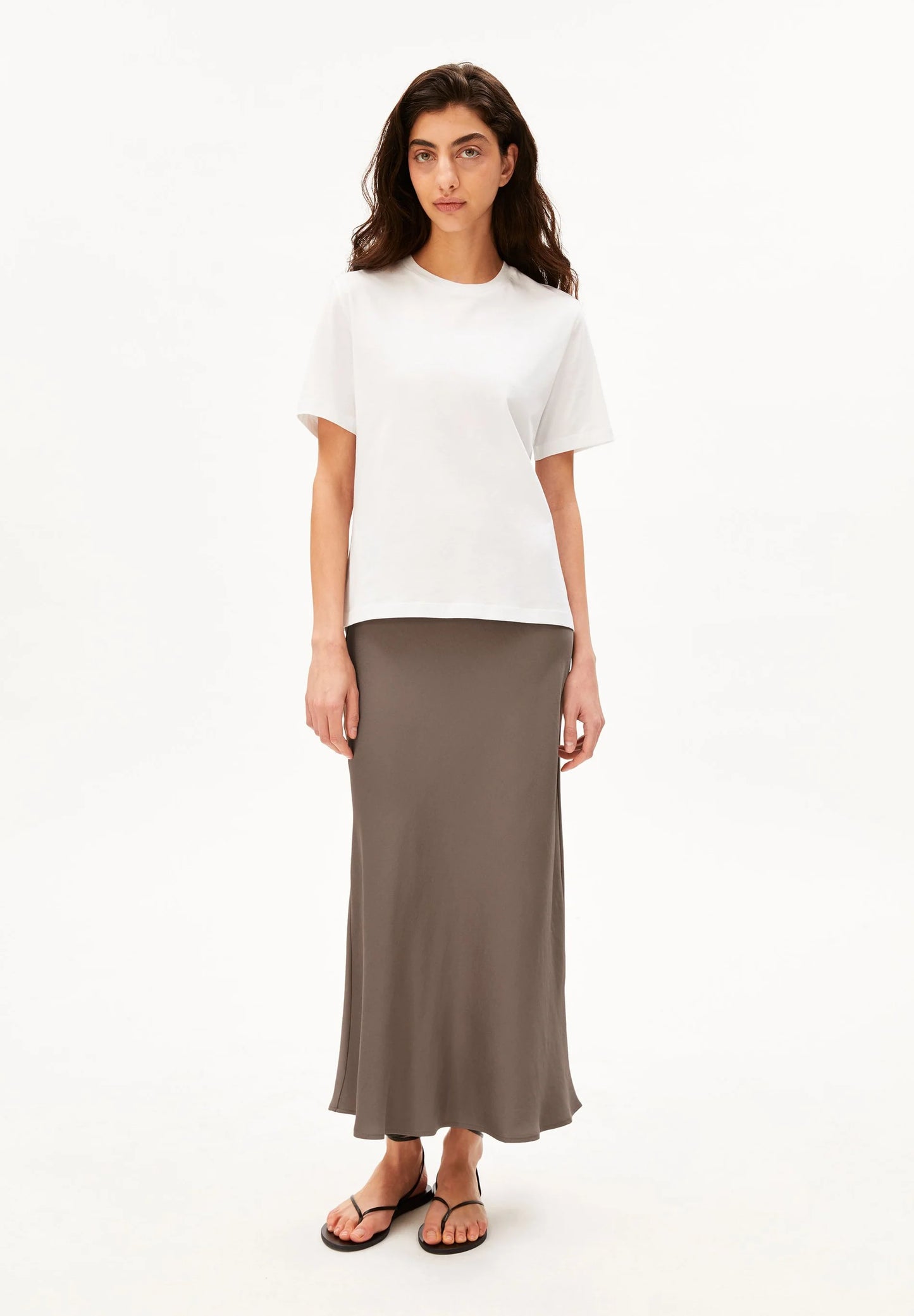LENOVAA SATIN SLIP-SKIRT in Walnut Creme - ARMEDANGELS Canada front view paired with white t-shirt on model