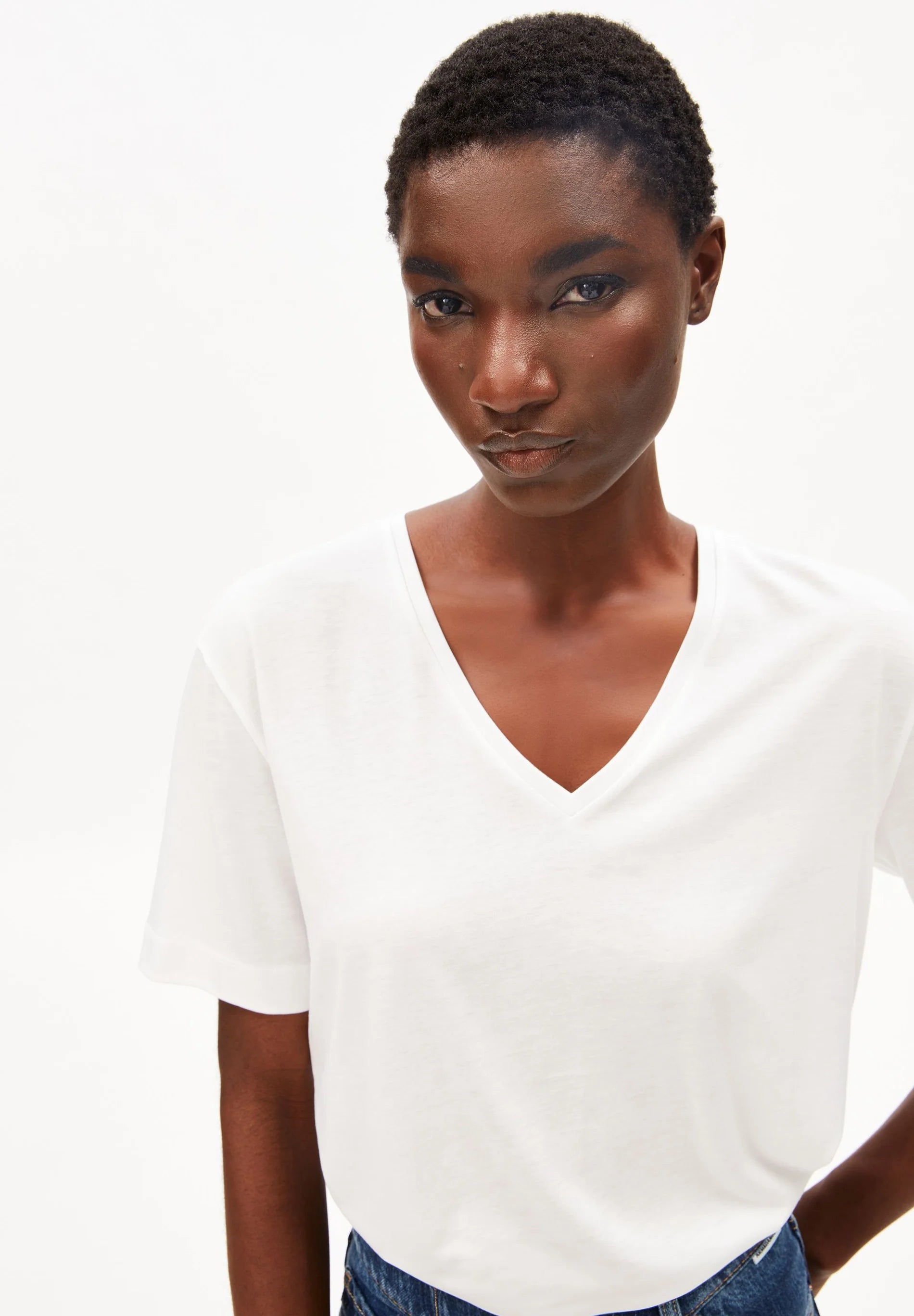 Close up of white tee - V-Neck T-Shirt – ARMEDANGELS Canada on model in Kelowna