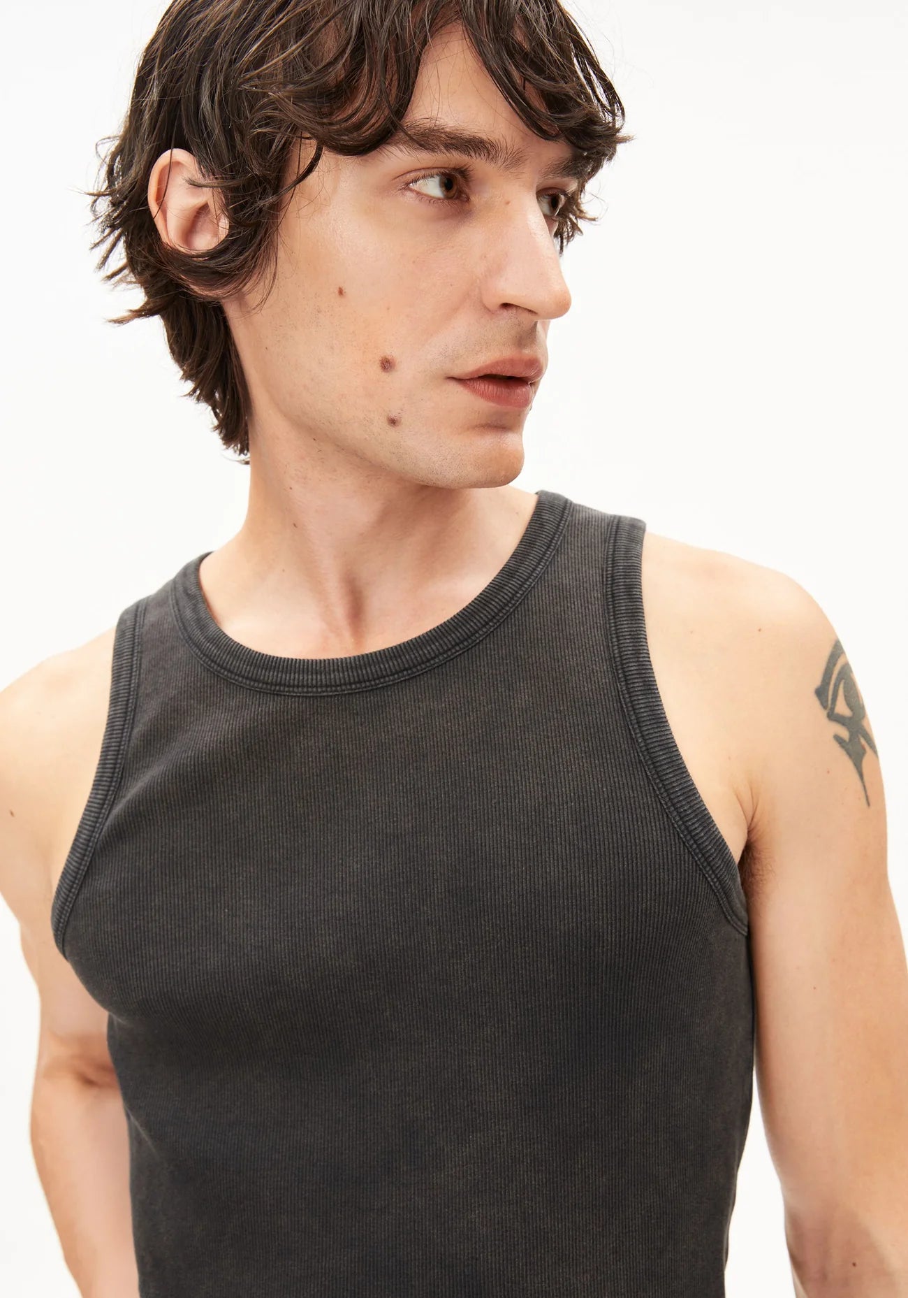 GMT DYE TANK TOP in Black-wash - ARMEDANGELS Canada garment dye black men's tank top close up view on model of neck and front in Kelowna