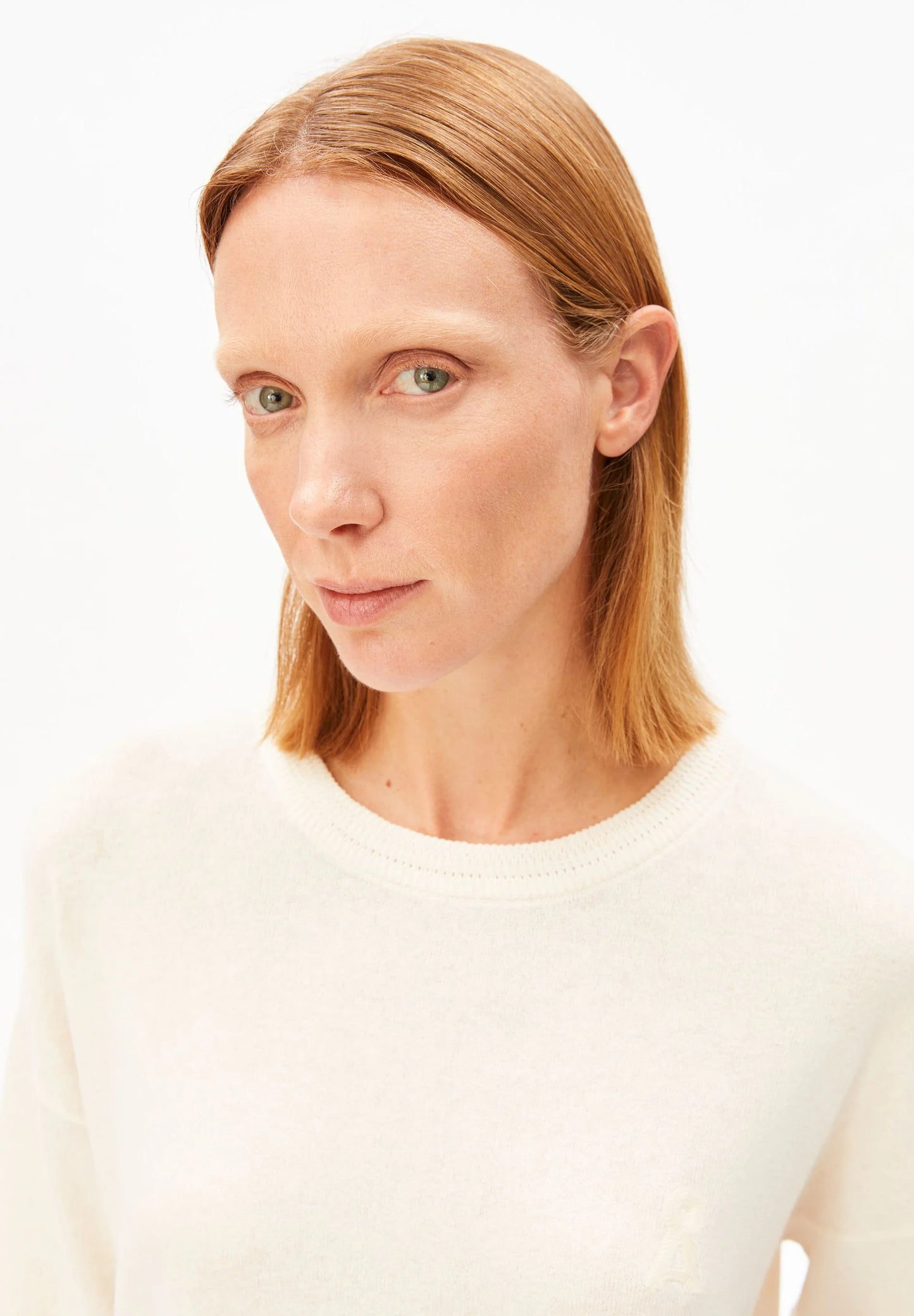 Close up of round neck Linen Blend Knit Sweater in Undyed – ARMEDANGELS Canada on model