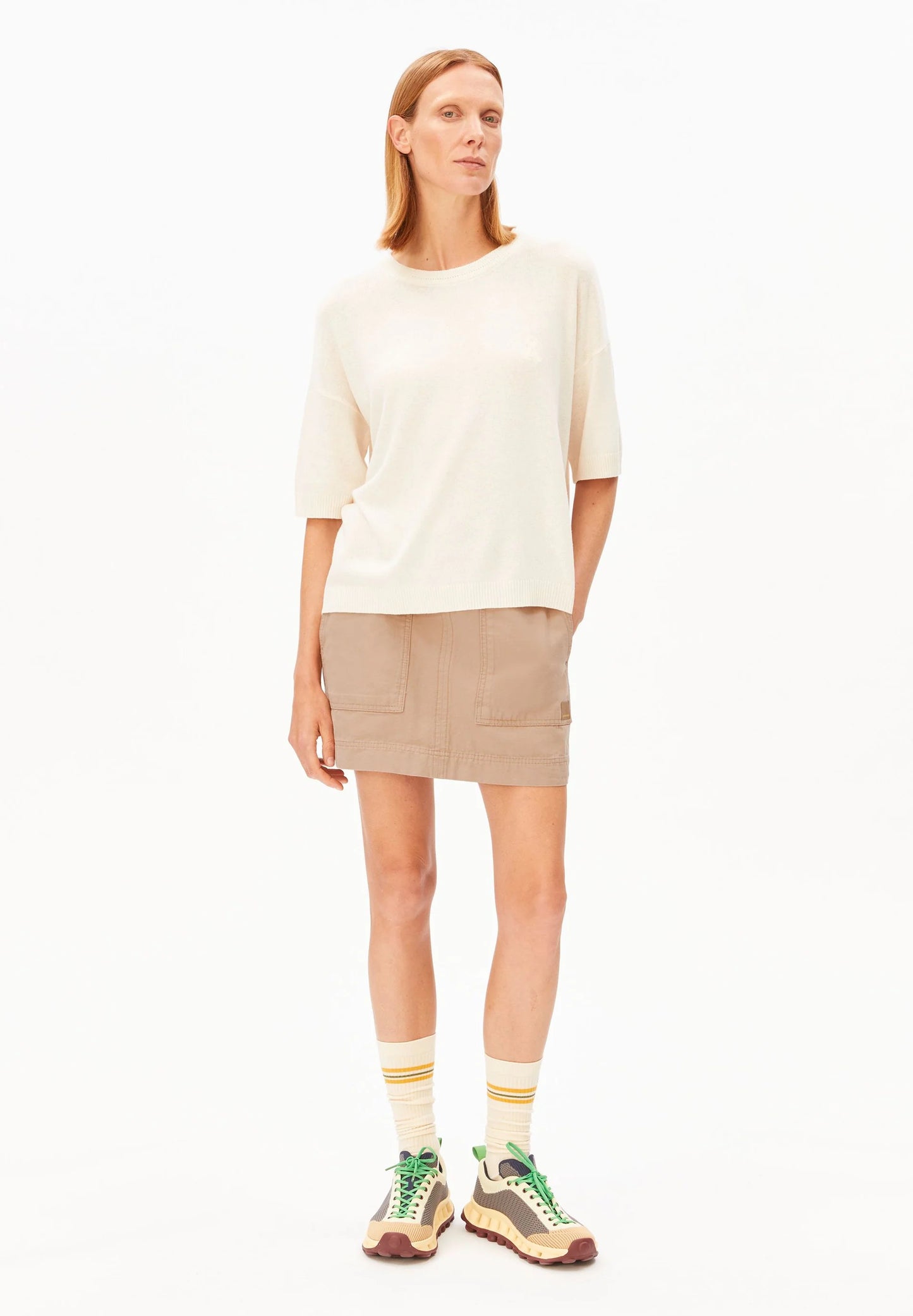 Linen Blend Knit Sweater in Undyed – ARMEDANGELS Canada front view on model with skirt in Kelowna
