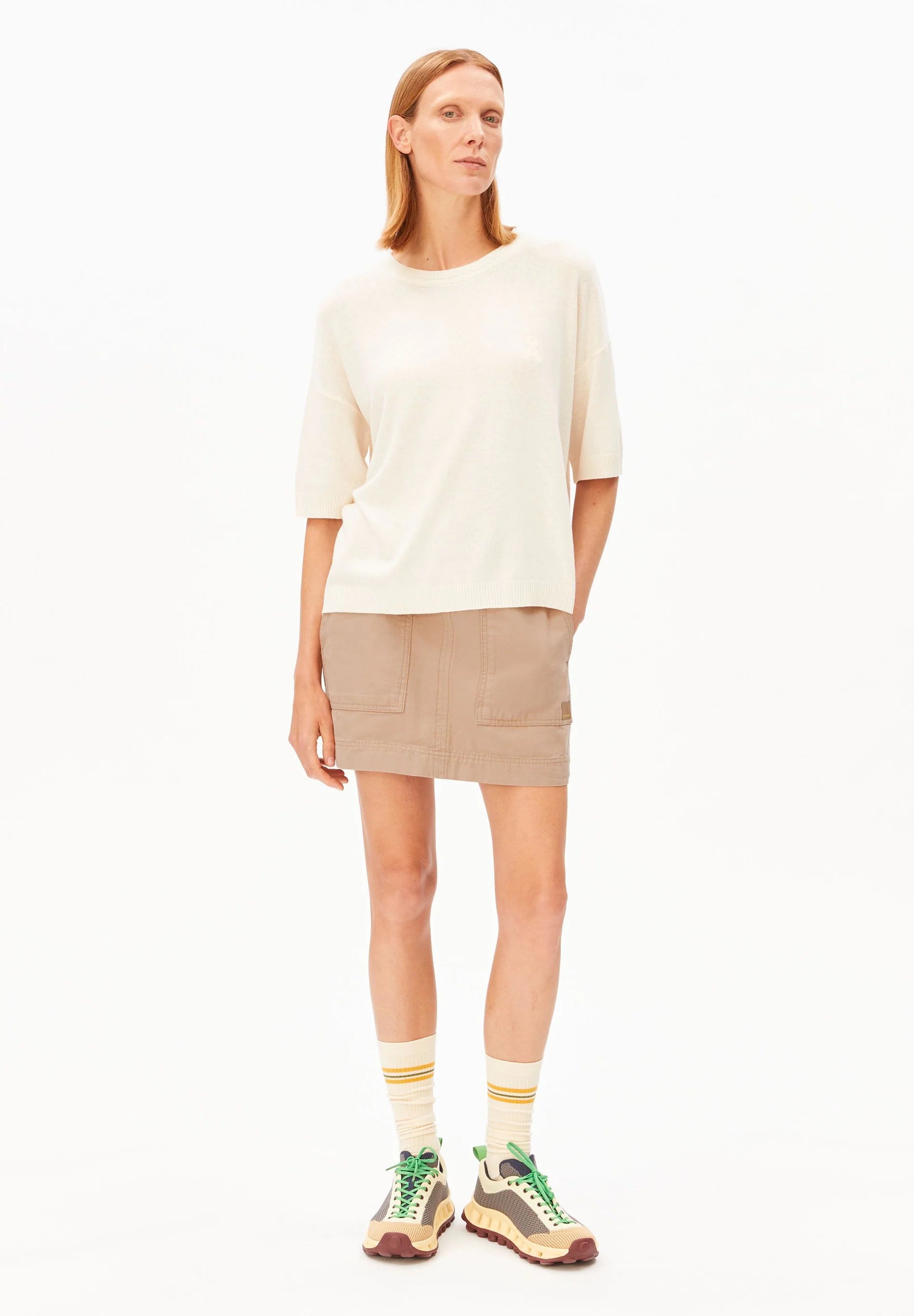 Linen Blend Knit Sweater in Undyed – ARMEDANGELS Canada front view on model with skirt in Kelowna