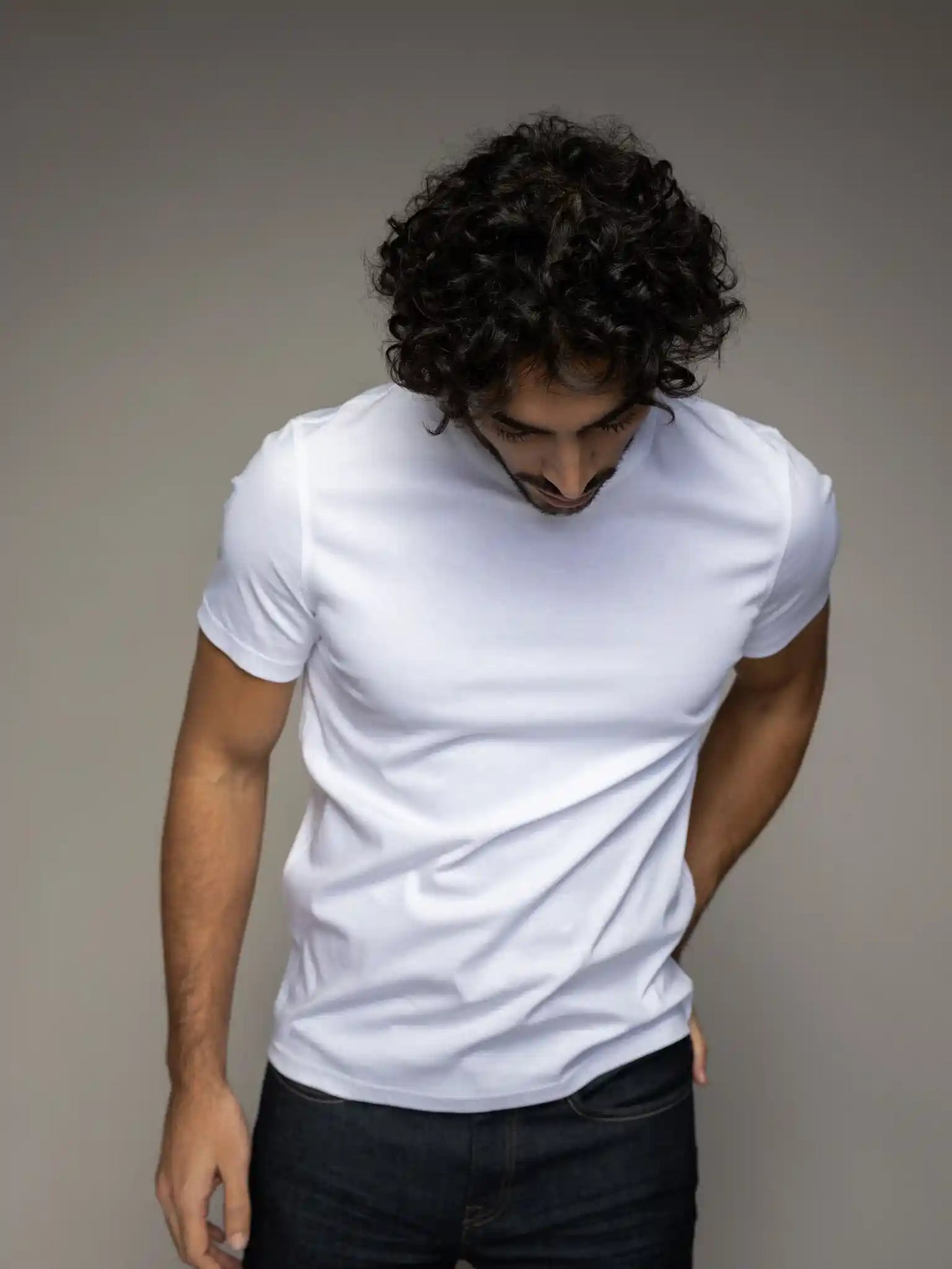 Styled view of the Mos Mosh Gallery V-neck tee in white on model front view at Textile Apparel Kelowna