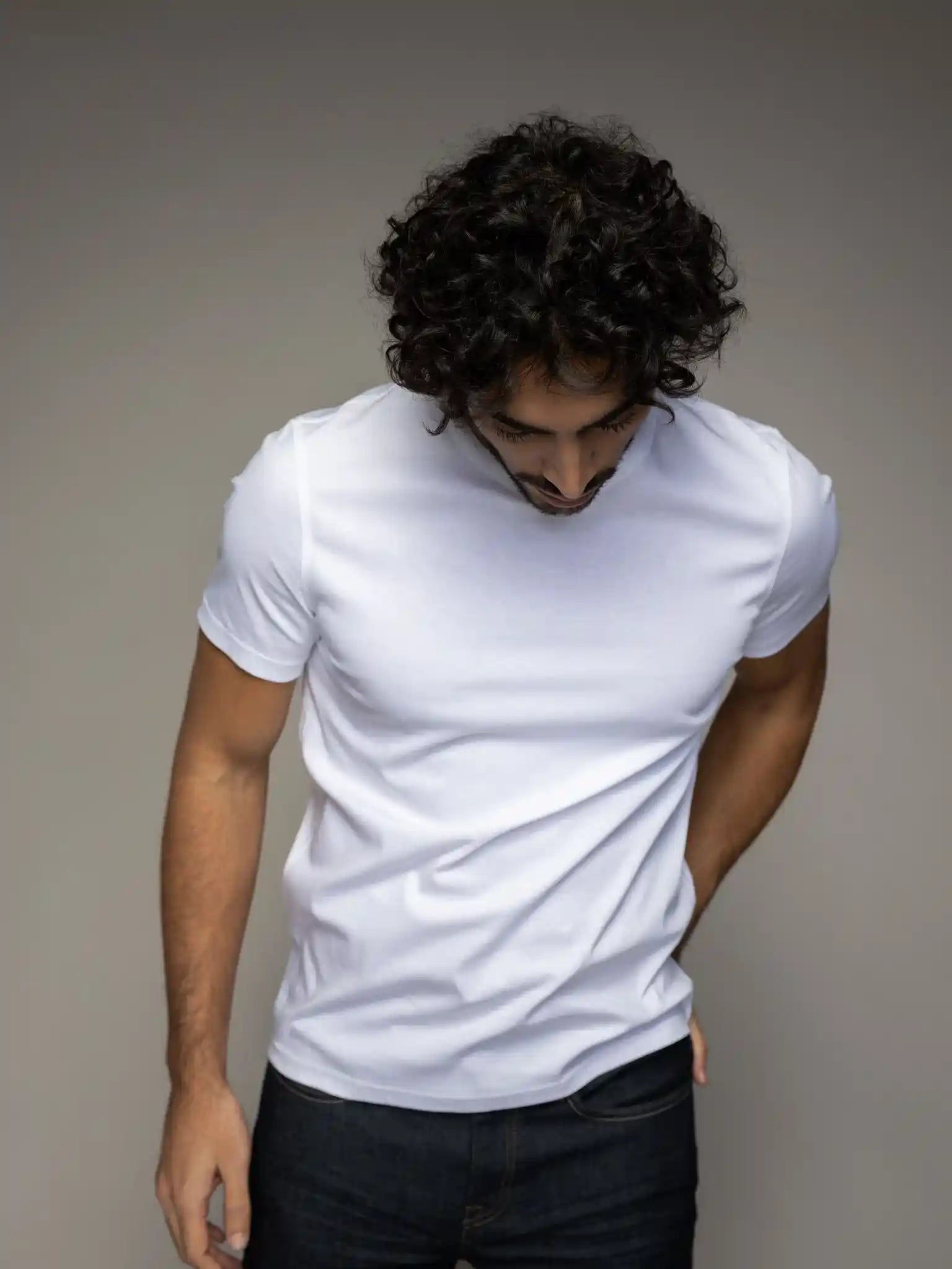 Styled view of the Mos Mosh Gallery V-neck tee in white on model front view at Textile Apparel Kelowna