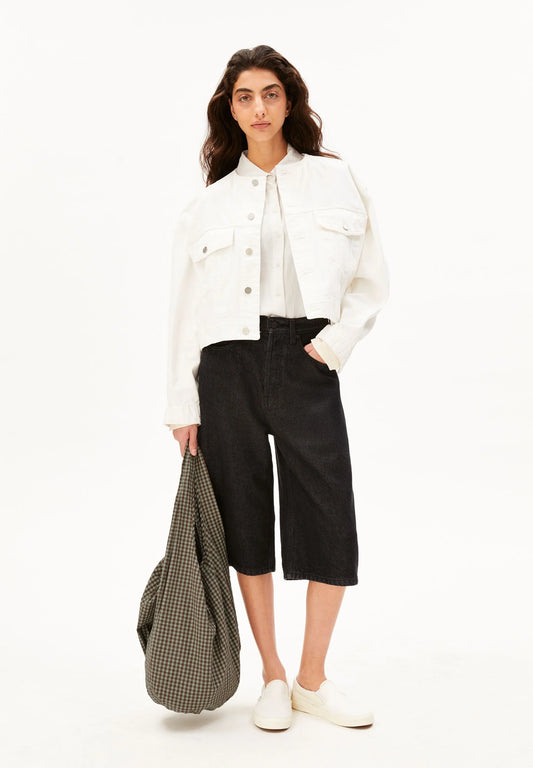 Mode, full front, holding brown and green checkered bag for Kelowna and Canada