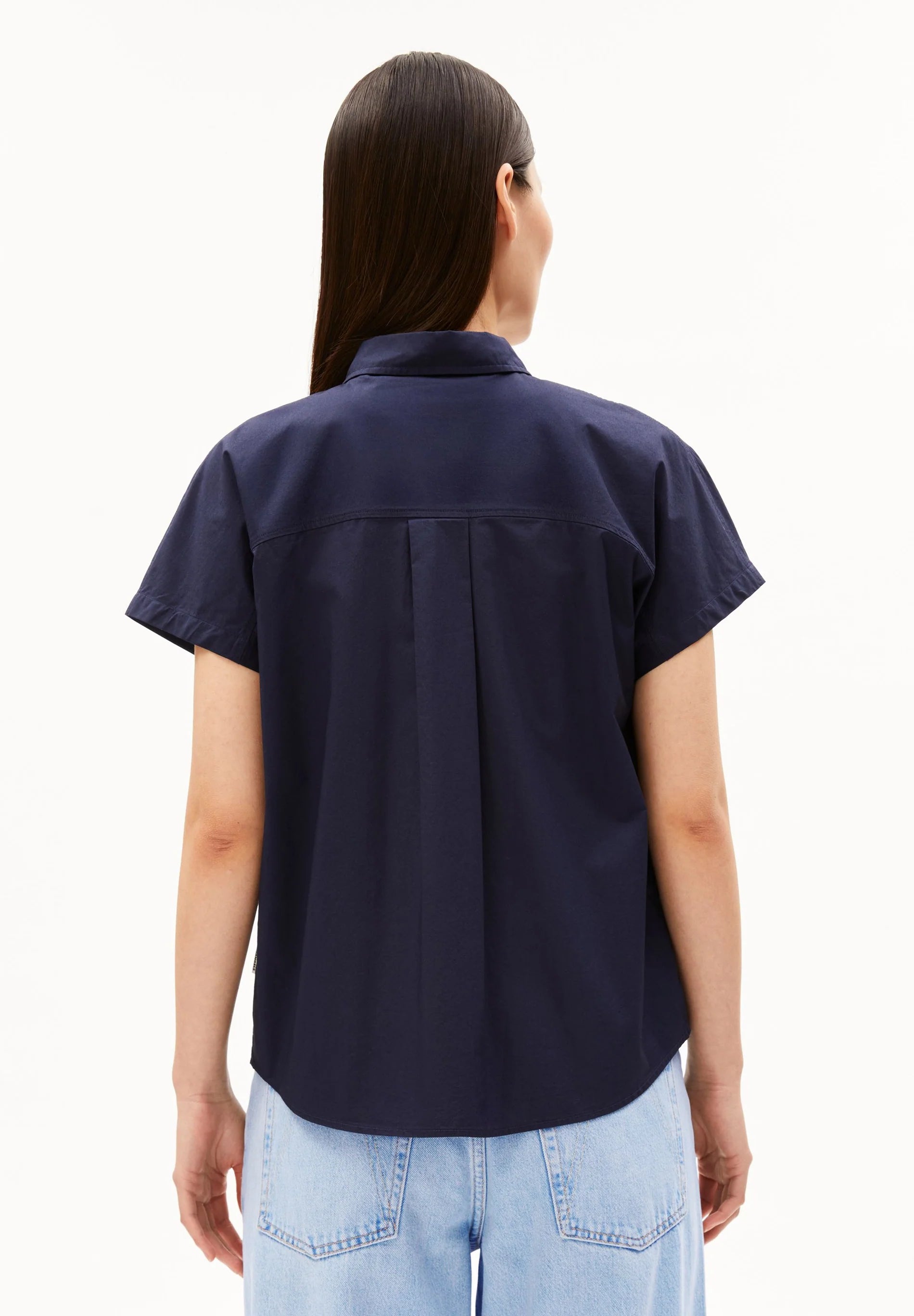Model wearing a navy blue short-sleeve shirt on a white background for Kelowna and Canada