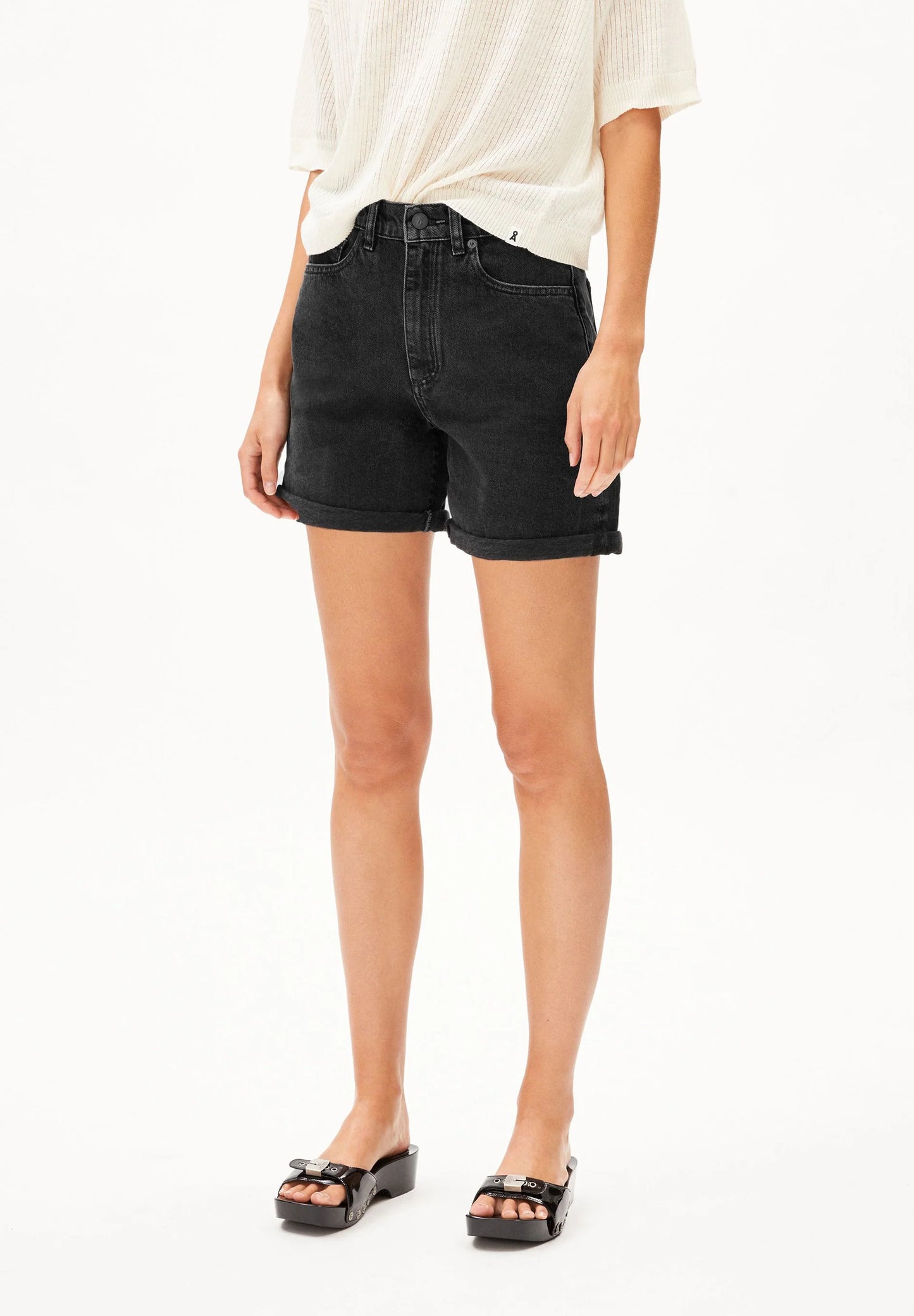 Person wearing black denim shorts on a white background for Kelowna and Canada