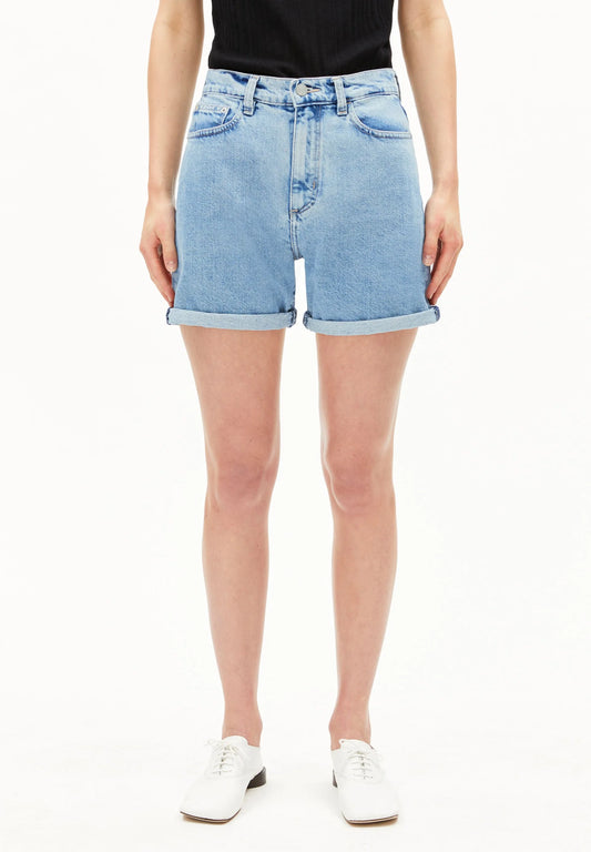 Person wearing light blue denim shorts on a white background for Kelowna and Canada