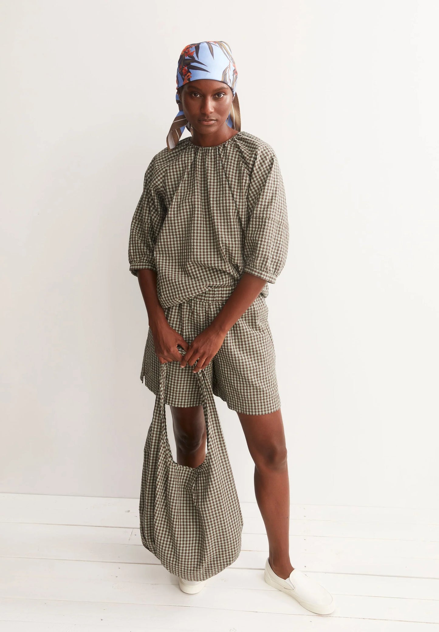 Model in green and brown check cotton shirt and shorts. full styled shot, for Kelowna and Canada