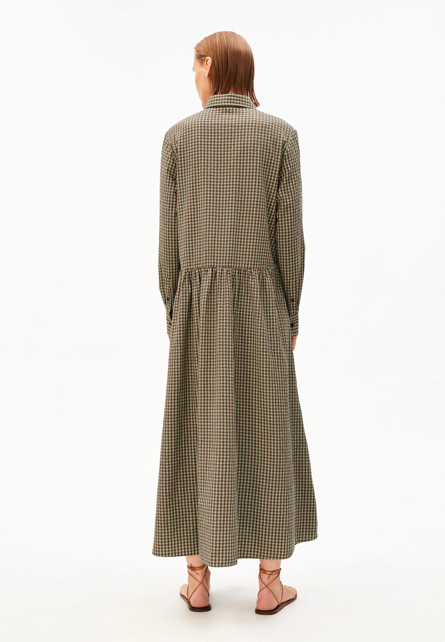 Backside model shot in green and brown check dress for Kelowna and Canada