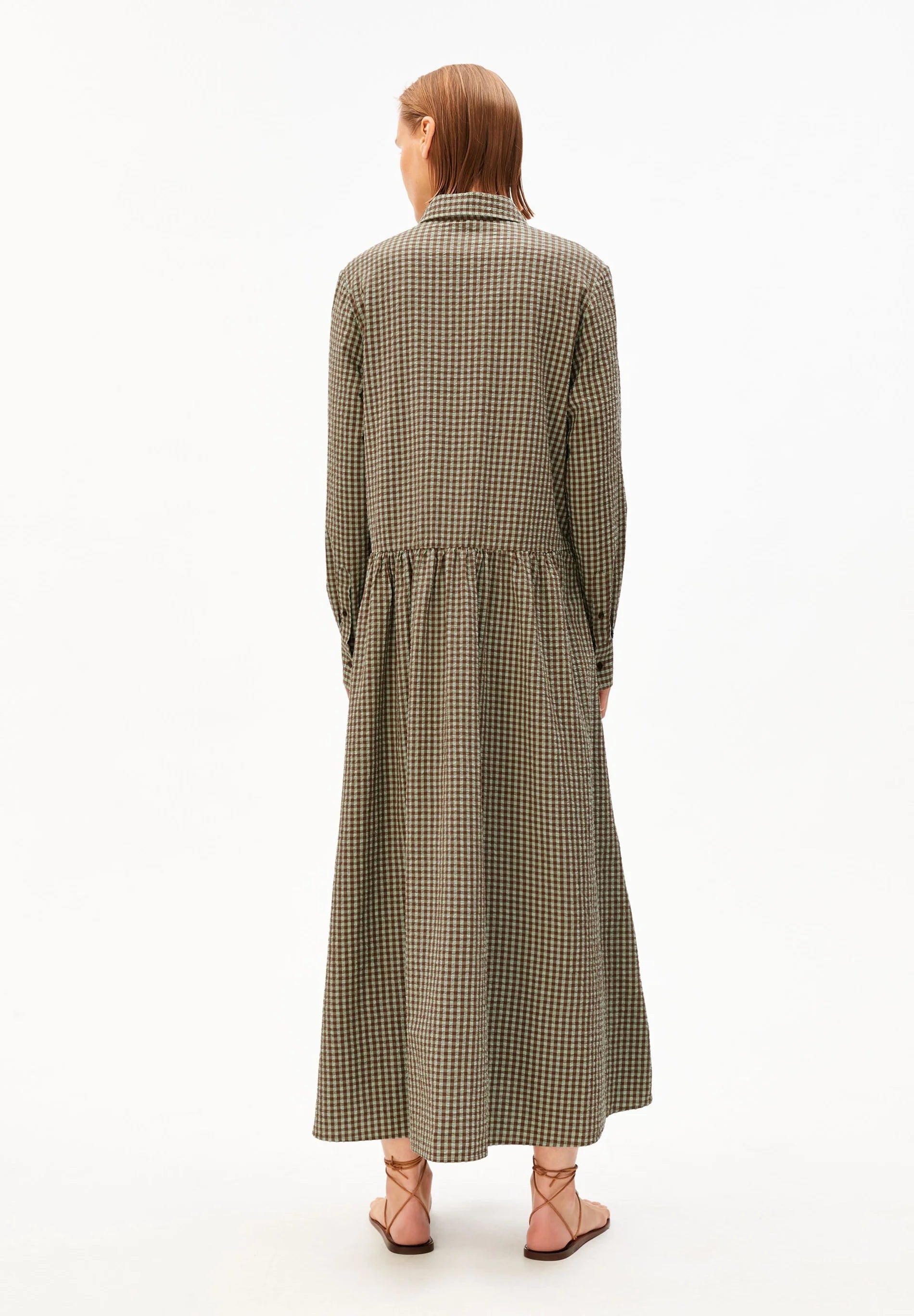 Backside model shot in green and brown check dress for Kelowna and Canada