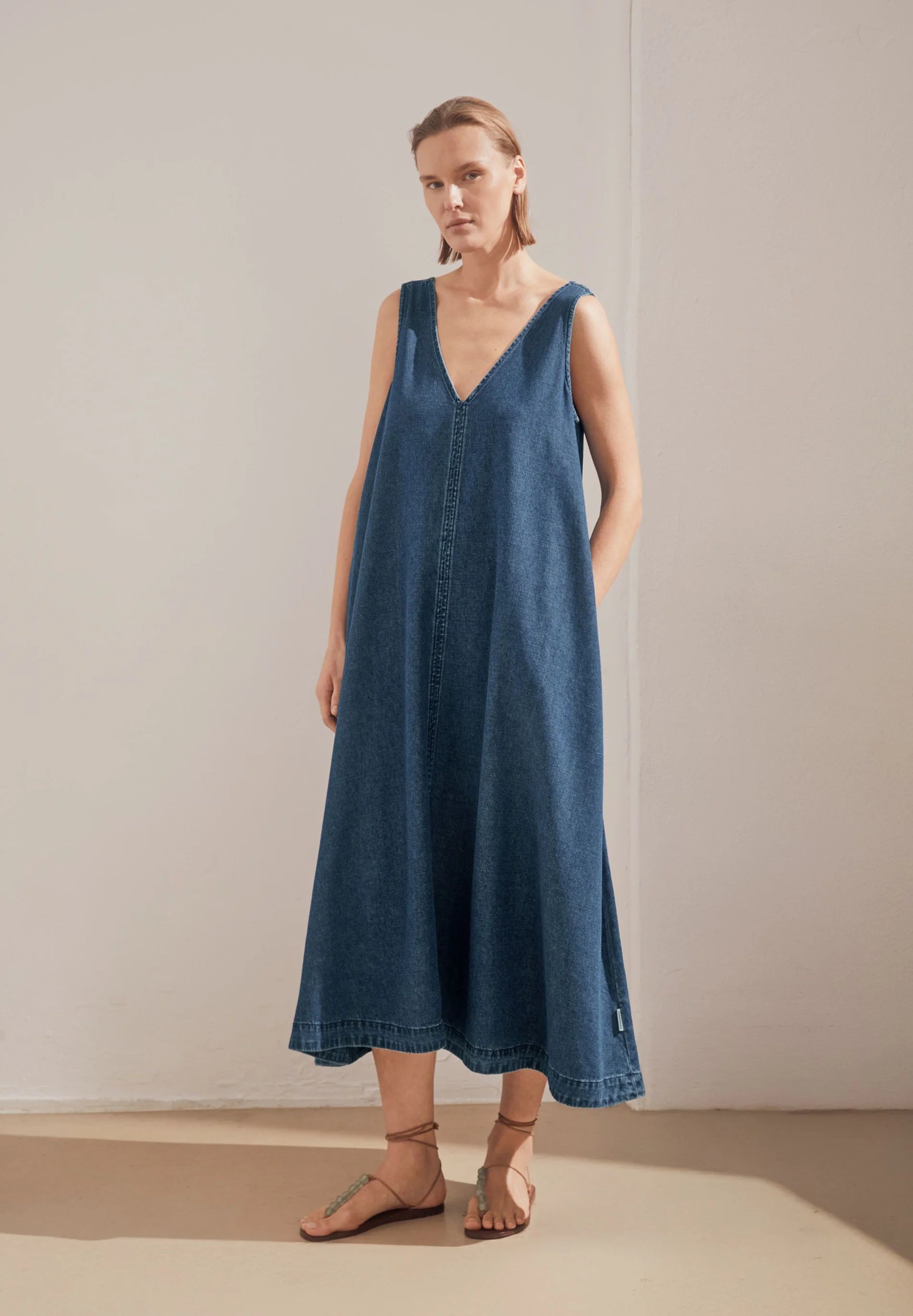 women's ARMEDANGELS Canada Denim V-Neck Midi Dress in Eau, full model front view lifestyle shot  in Kelowna