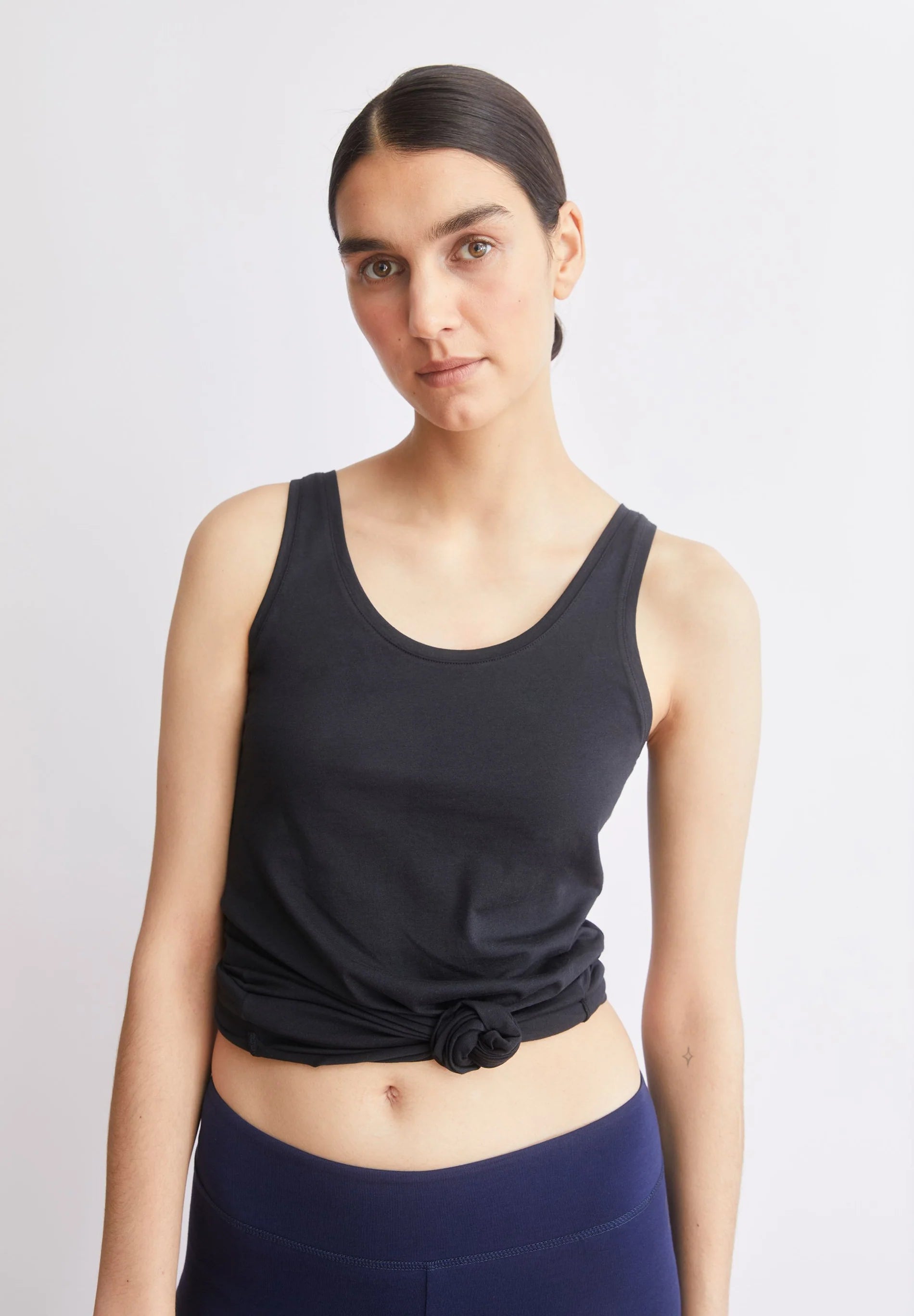 women's ARMEDANGELS Canada Single Jersey Top in Black, view on model tied with a knot  in Kelowna