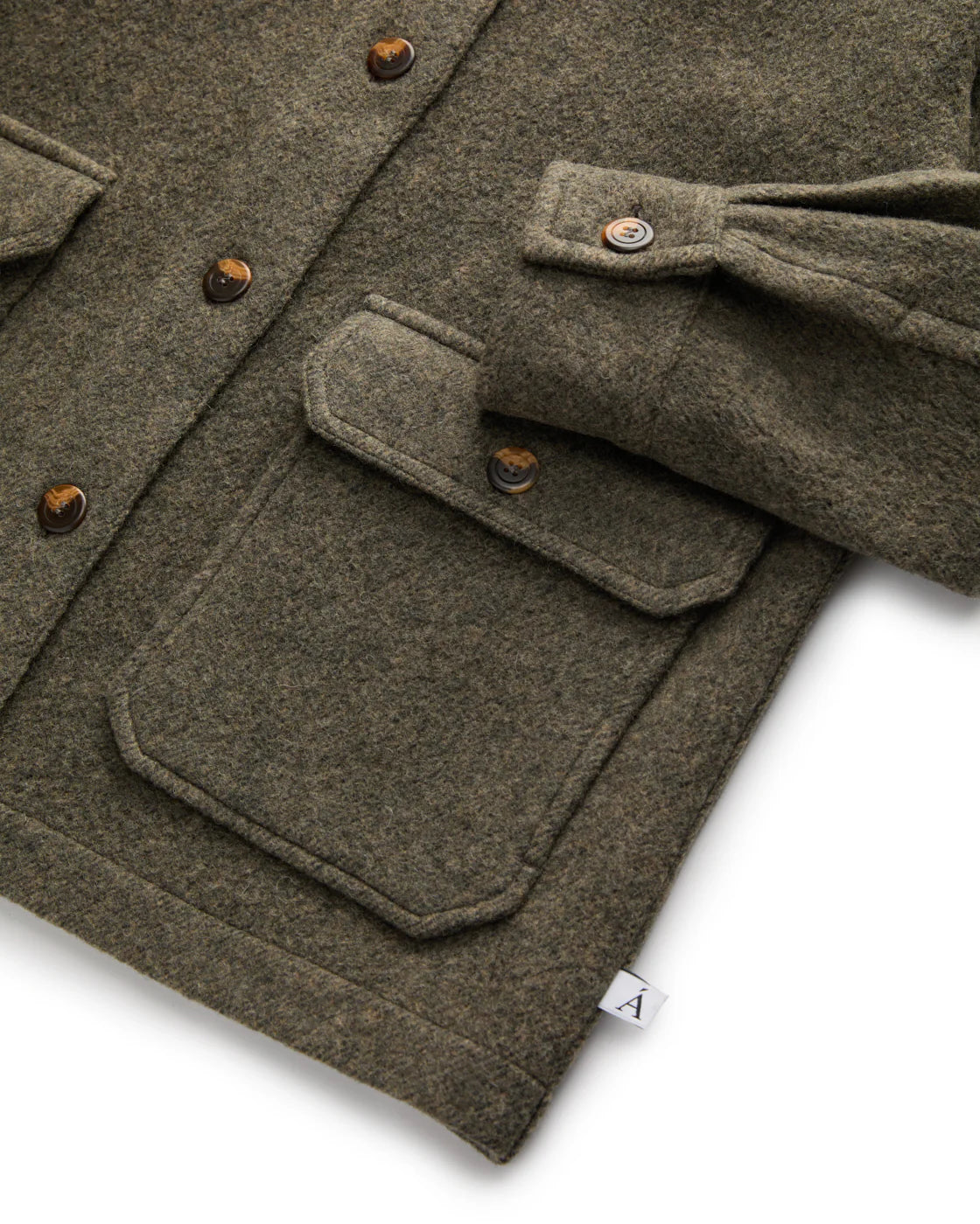 green coat laying flat close up