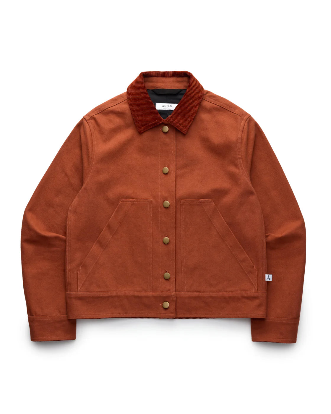 RED-ORANGE COTTON WORKWEAR JACKET WITH A RED-ORANGE CORDUROY COLLAR, LAID FLAT AGAINST A WHITE BACKGROUND