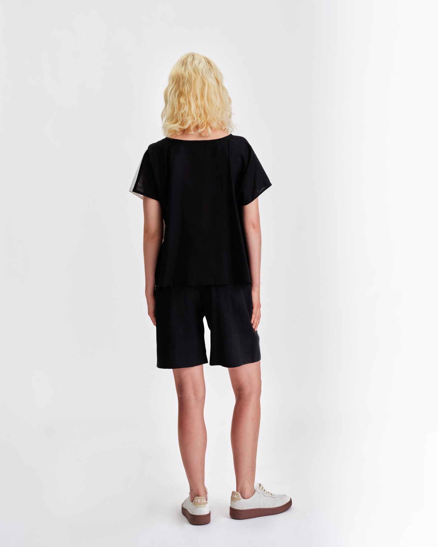 Back view of a black Jennifer Glasgow Design top paired with matching shorts for a stylish summer look