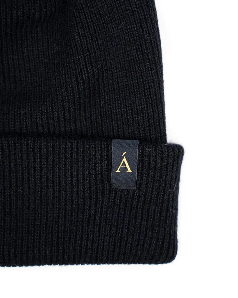 Anian Black ribbed knit wool toque with folded cuff and gold A logo tag by Anian accessories brand in Kelowna