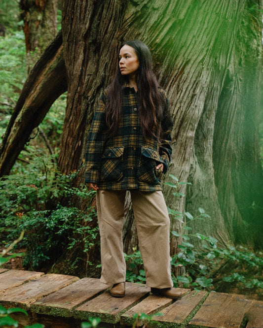 Anian Georgia coat plaid in dark green and blue with pockets worn outdoors in a natural setting in Kelowna