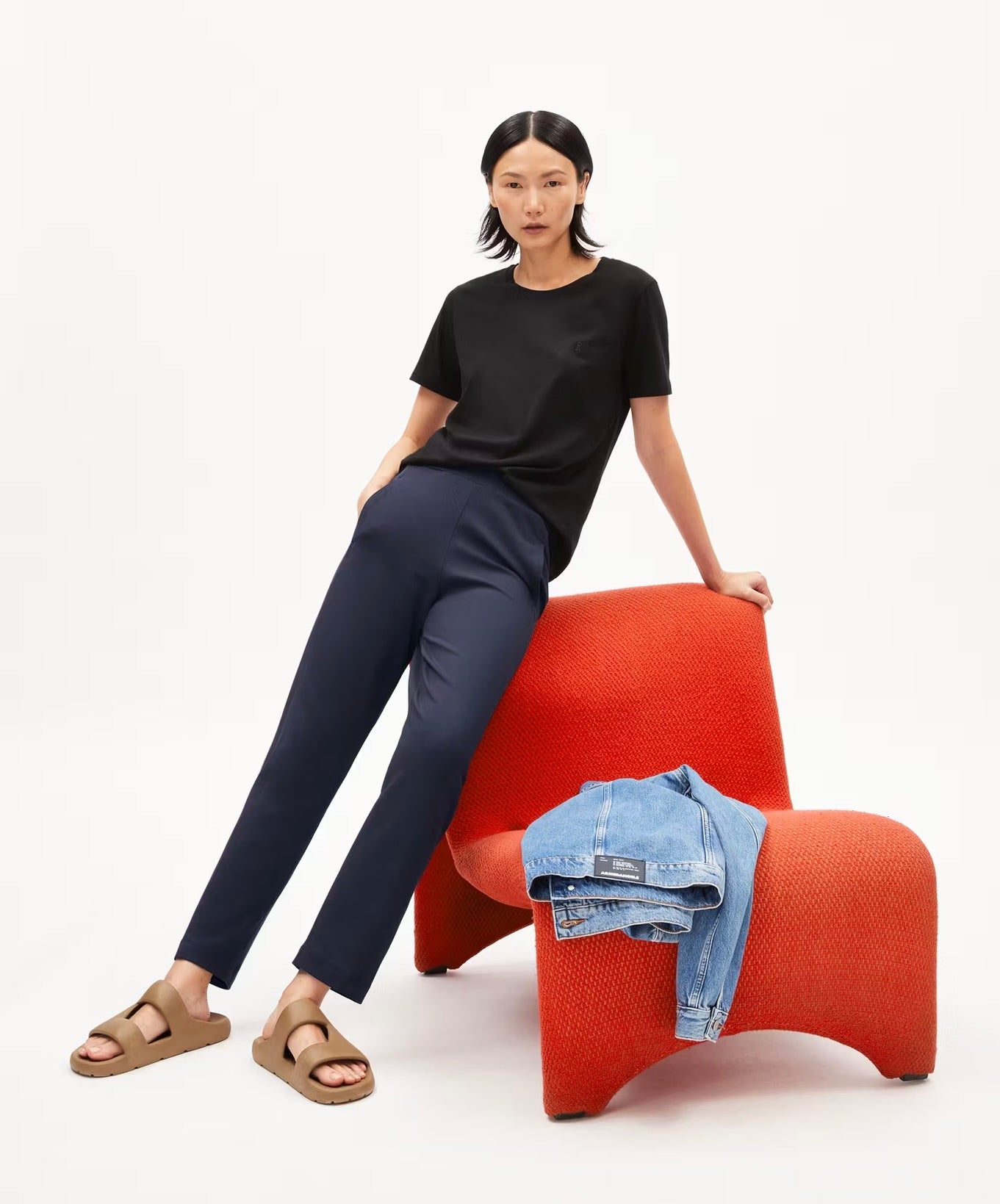ARMEDANGELS Canada Magdaalena Jersey Pants navy slim fit pants worn by woman with black t-shirt sitting on chair