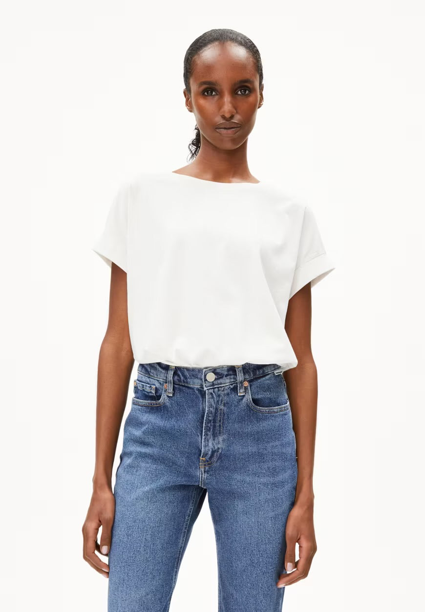 ARMEDANGELS Canada white relaxed fit short sleeve blouse paired with blue high waist jeans in Kelowna
