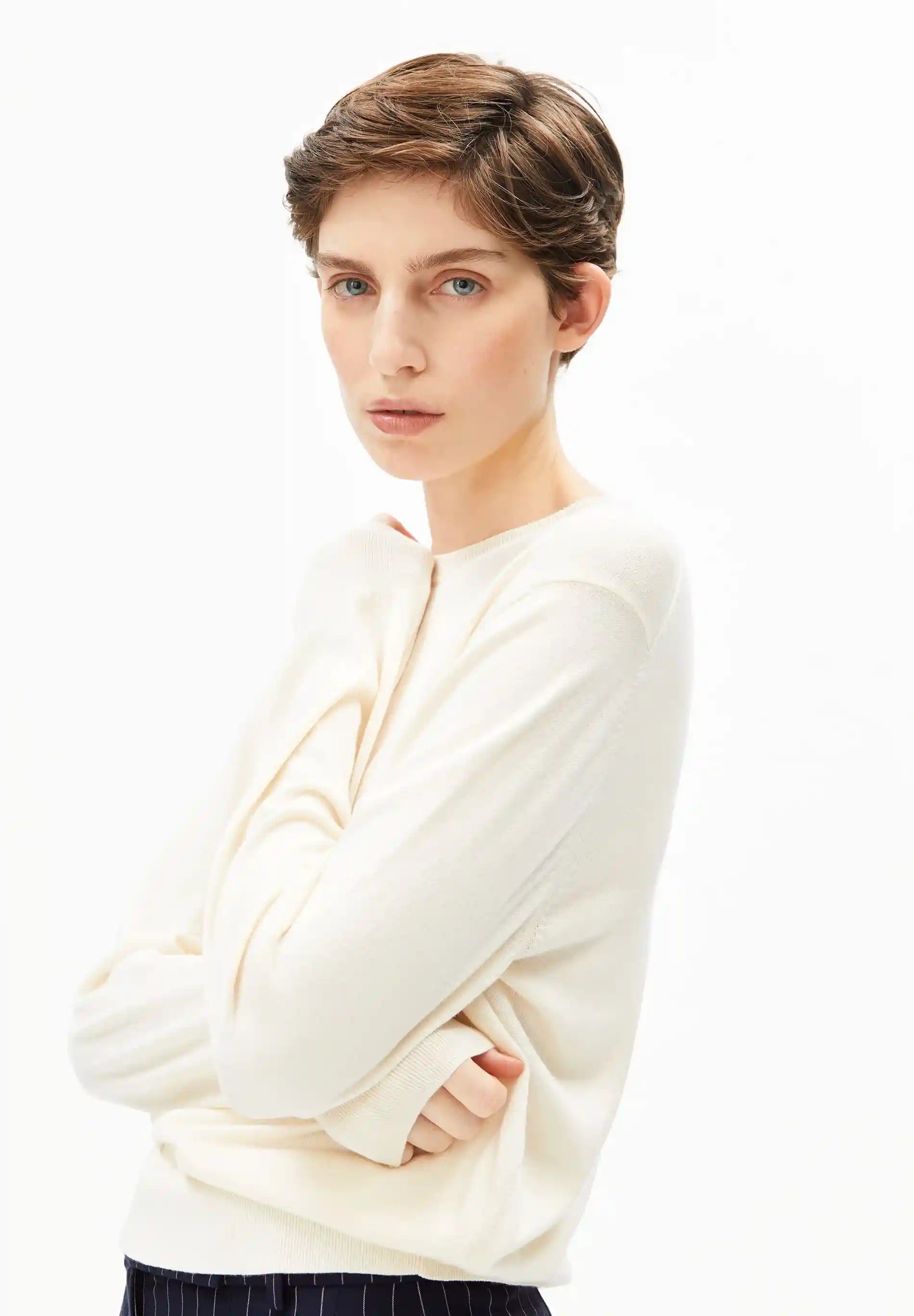 Side view of oatmilk fine knit top with regular fit - sustainable women's knitwear by ARMEDANGELS Canada