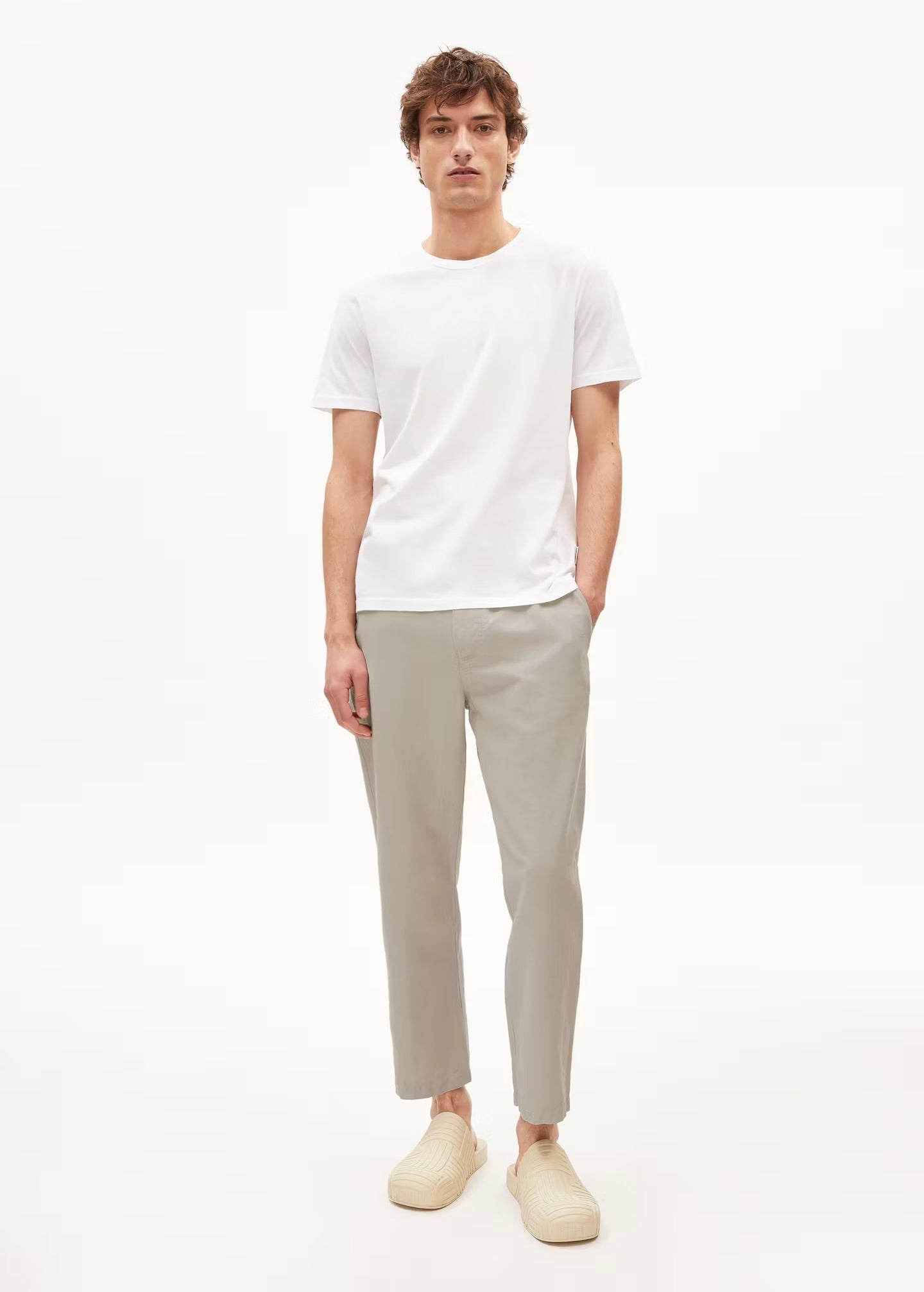 Men's ARMEDANGELS Canada cotton t-shirt in white, paired with light grey pants for a casual look