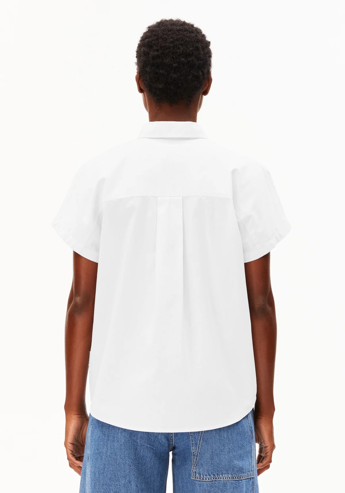 Cropped image of backside of model wearing ARMEDANGELS Canada white poplin collared shirt against a white background