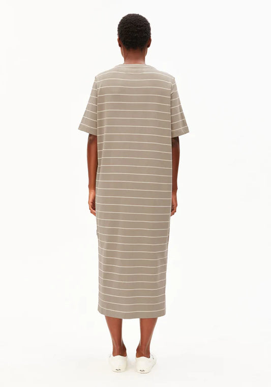 Backside of model wearing ARMEDANGELS Canada long light brown striped t-shirt dress with white background