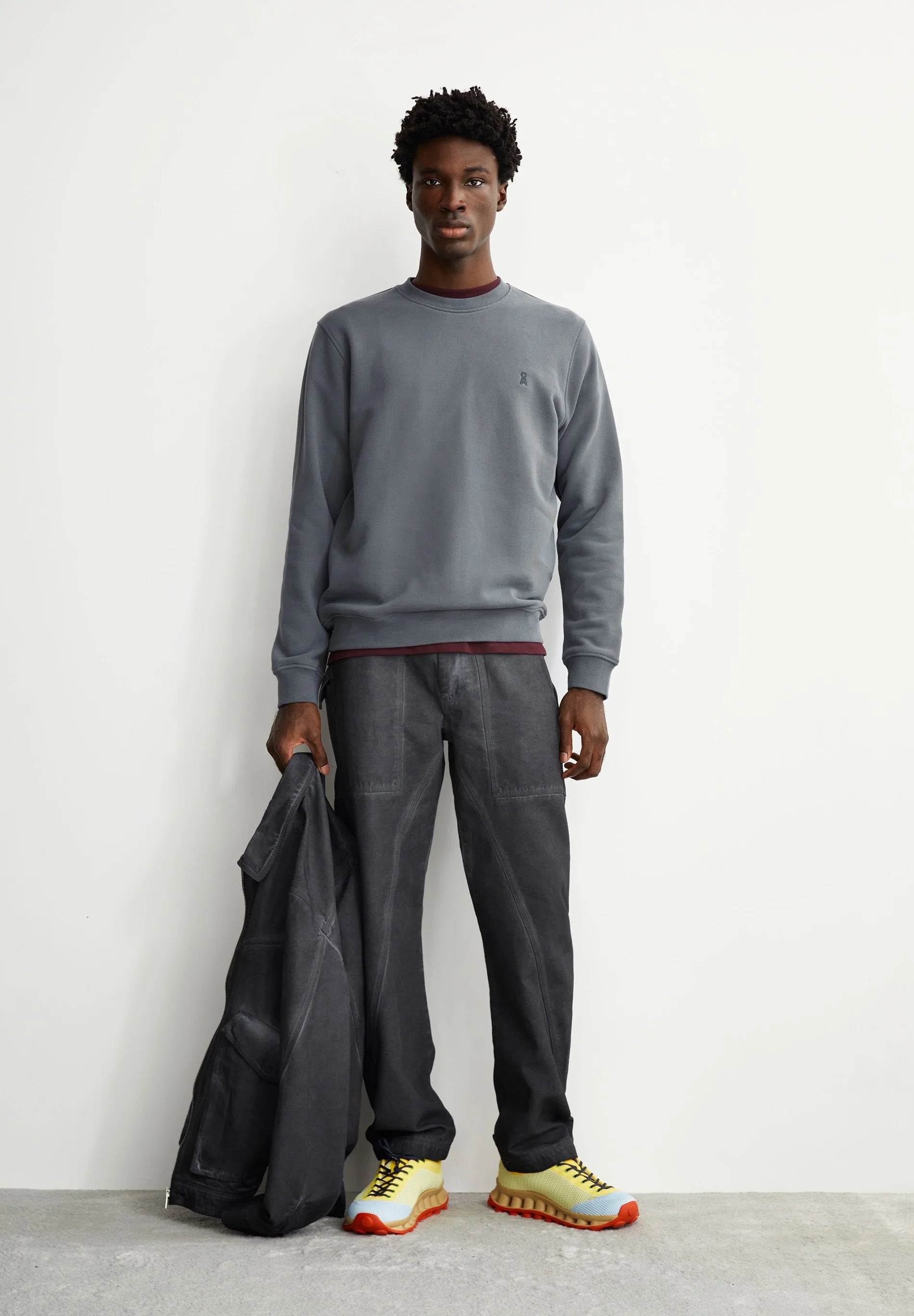 Men's ARMEDANGELS Canada  sweatshirt in gray with a classic fit, paired with dark pants and colorful sneakers
