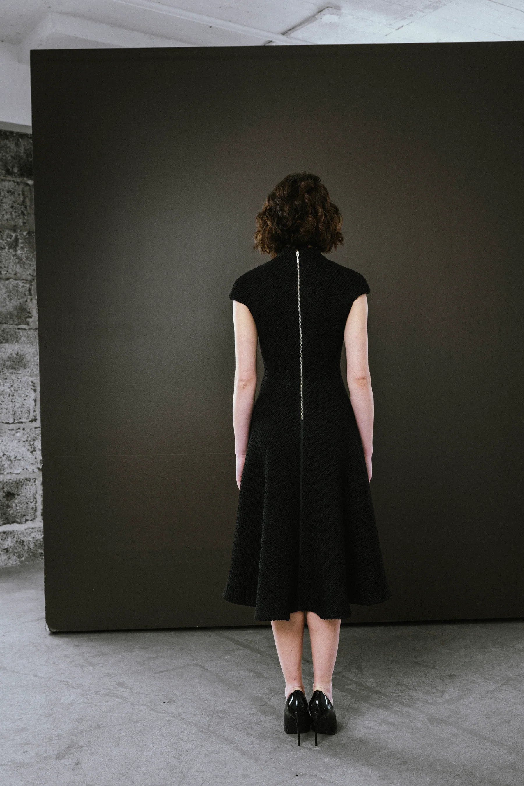 Elegant black dress by BodyBag by Jude with a fitted silhouette and zip closure at the back in Kelowna