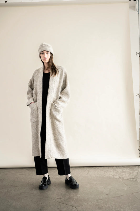 BodyBag by Jude long cream textured cardigan with pockets worn over black outfit and matching beanie in Kelowna