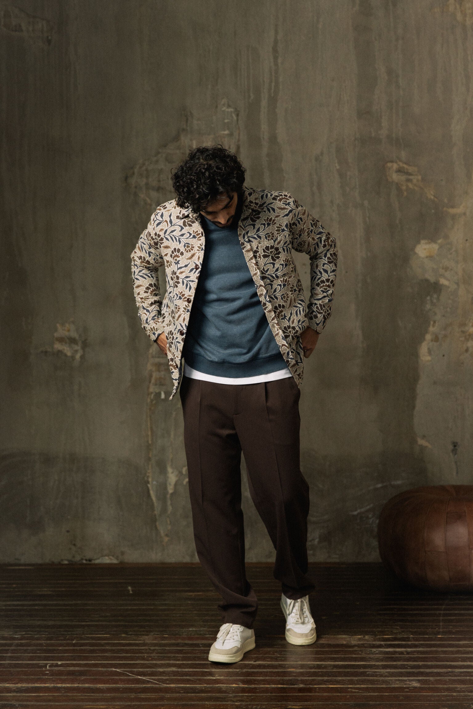 Mos Mosh Gallery model wearing organic men's overshirt with floral print over blue sweatshirt and brown pants in Kelowna