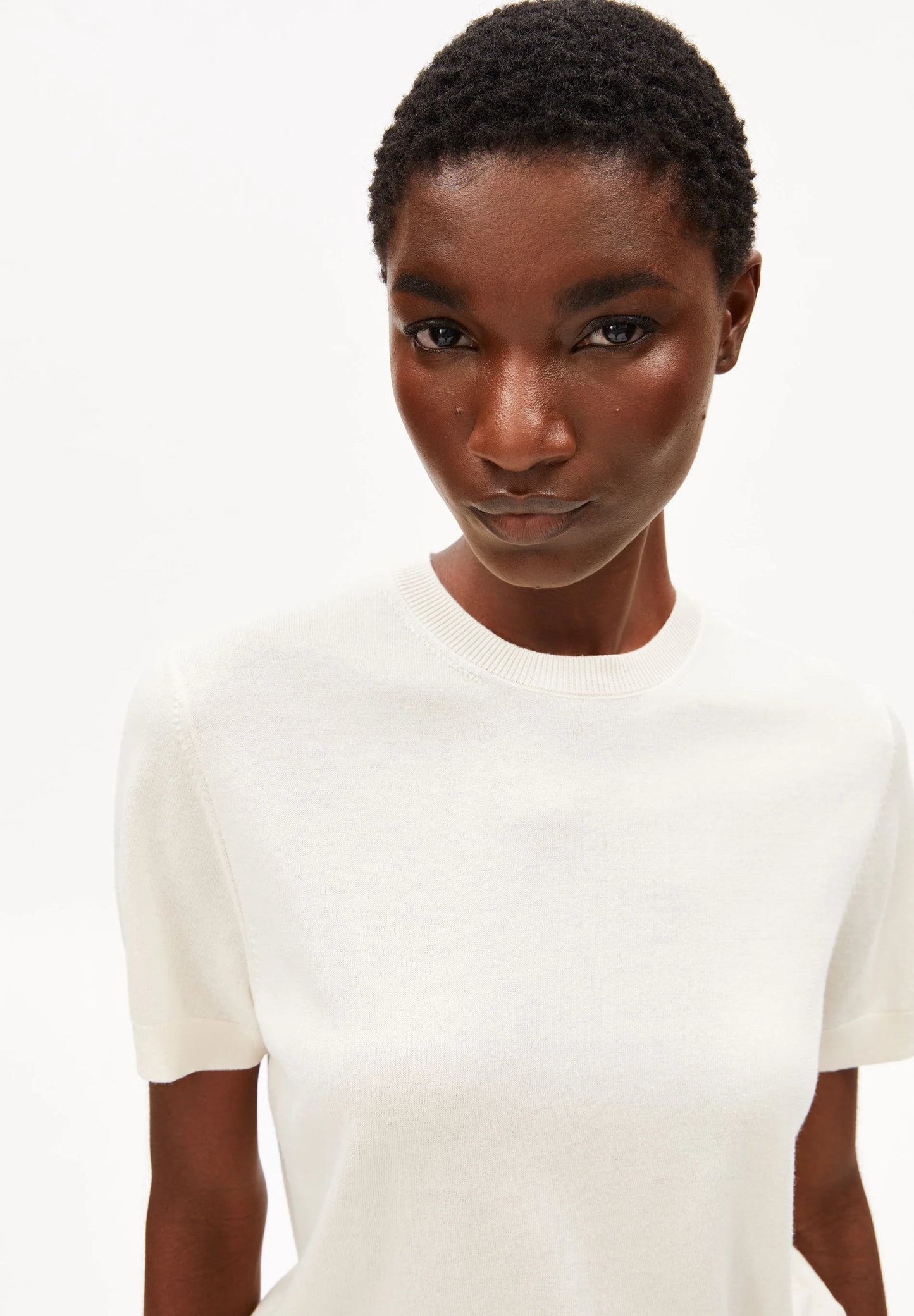 ARMEDANGELS Canada - FINE Knit Sweater in Oatmilk close-up view on model of round neckline and sleeves